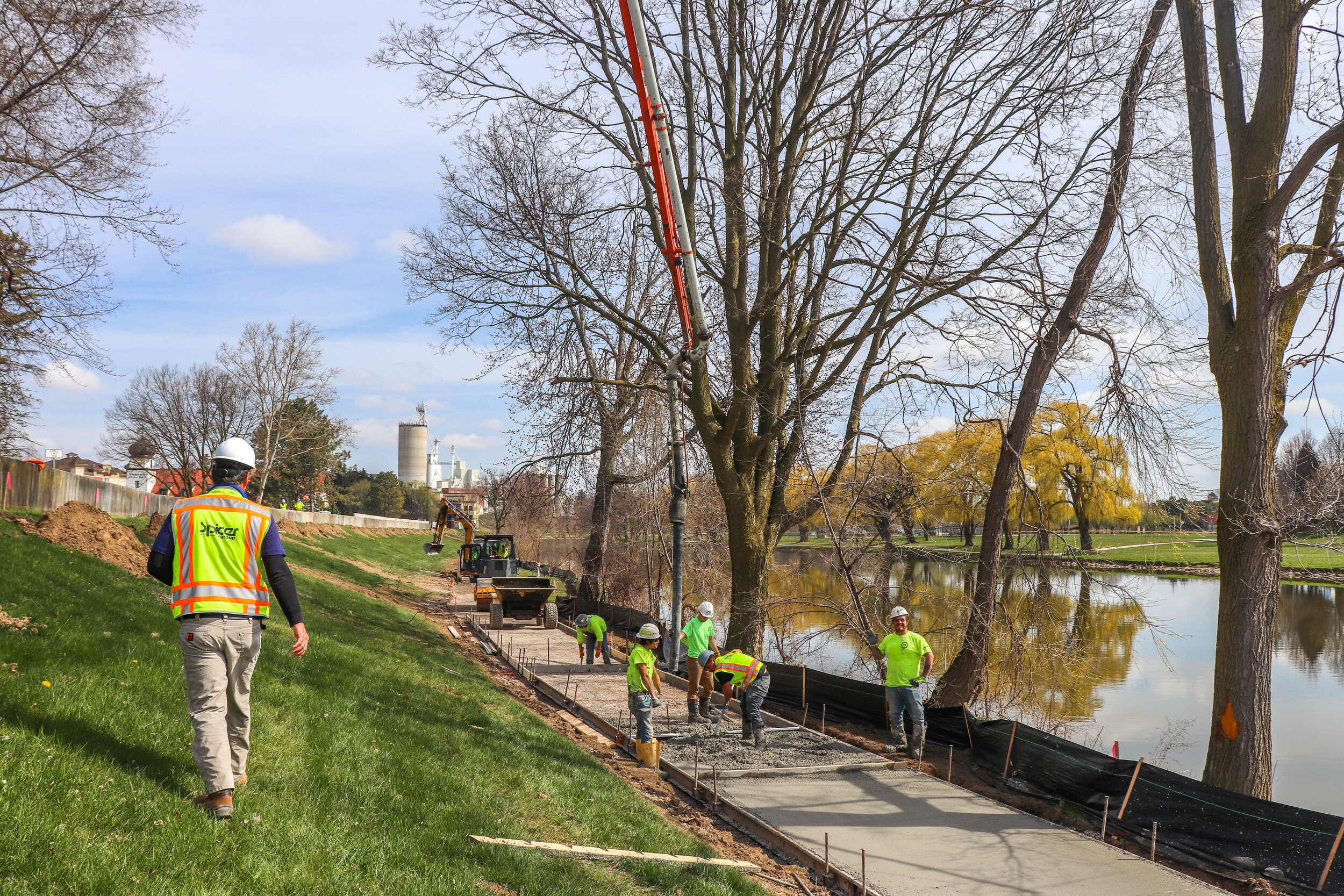  Spicer Group Construction Inspector Ben Scherzer walks along a new pathway being poured along the Cass River in the City of Frankenmuth.&nbsp; 