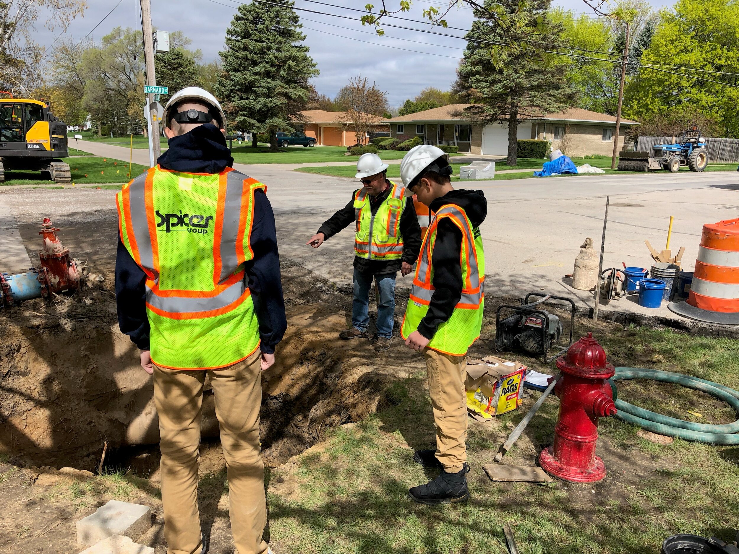  Construction Services Technician Mark Goss leads a few Swan Valley High School students around a construction site during a job shadowing event. 