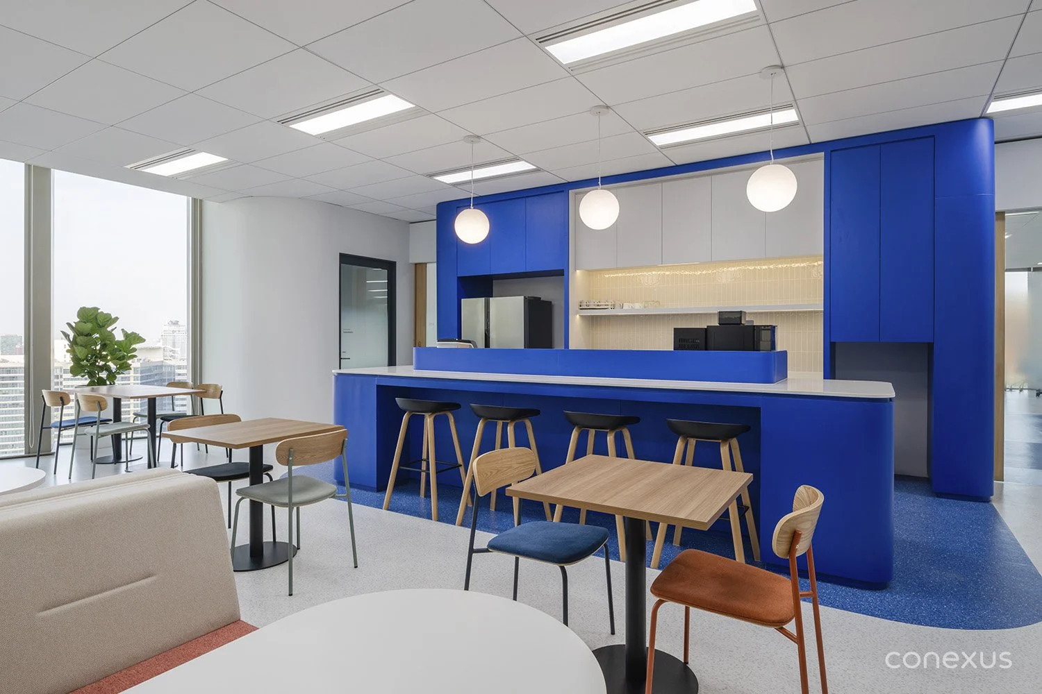  Samsonite blue defines the social hub, creating a bold yet disciplined focal point. 