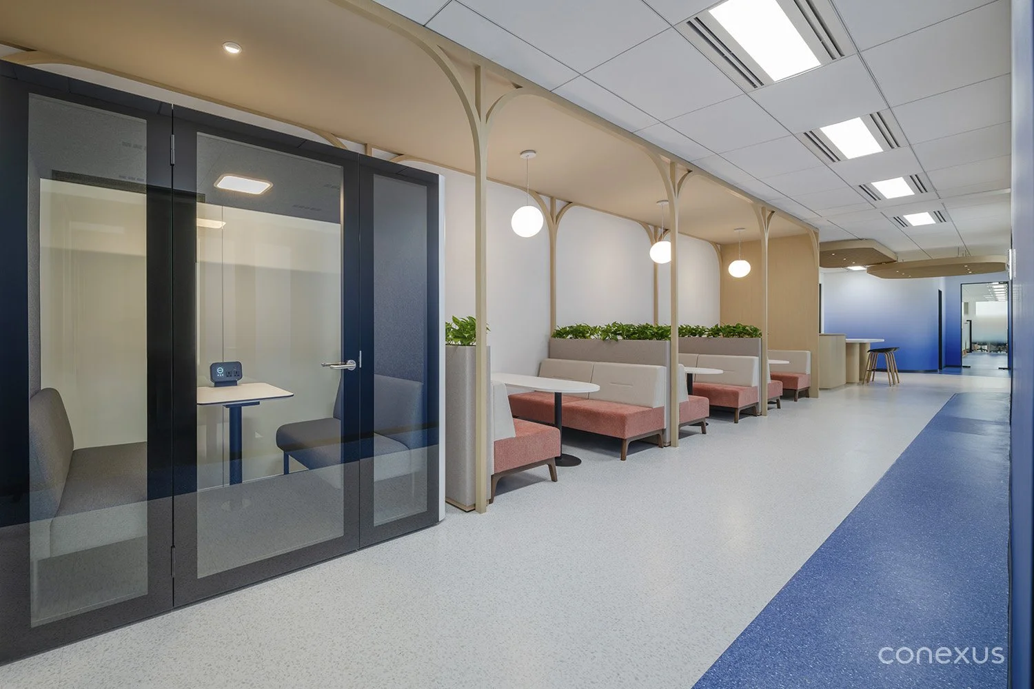  A corridor balancing private focus booths with soft lounge seating for in-between moments. 
