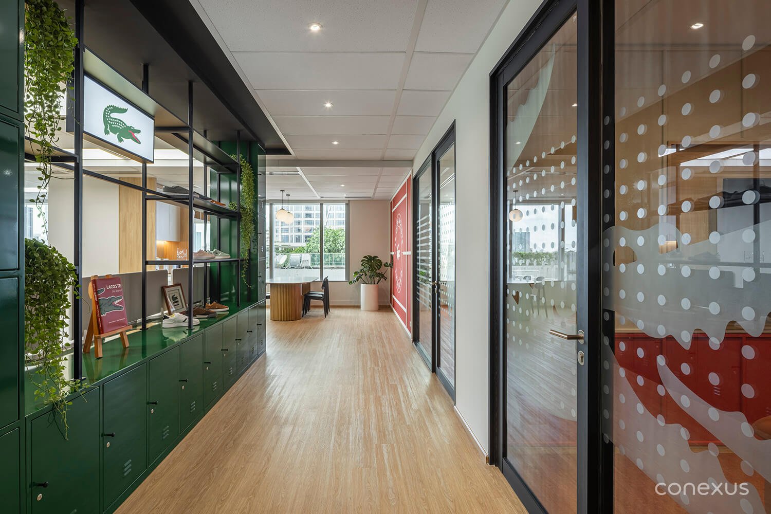  A central spine anchored by the green locker wall, organising circulation while separating public and private zones.  