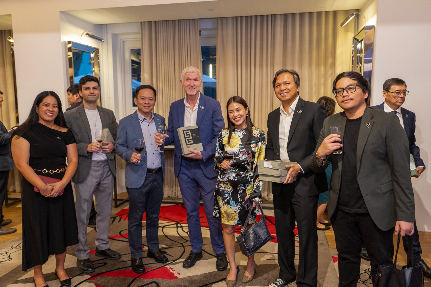  Celebrating the success of our collaboration with a toast in good company. 