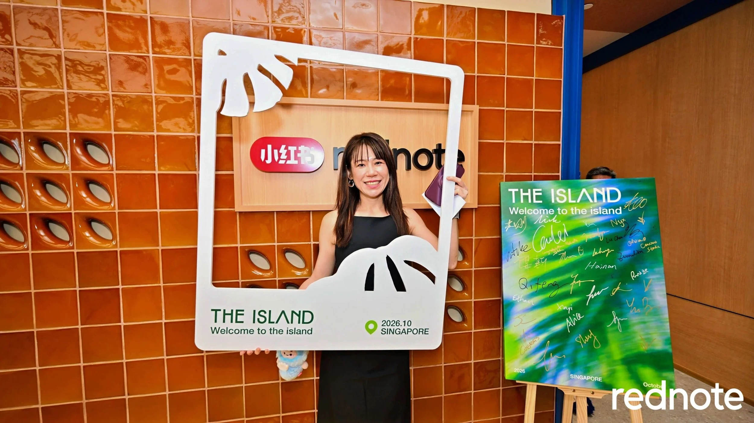  Our Senior Business Development Manager, Sherry Fan, poses with The Island’s commemorative frame. 