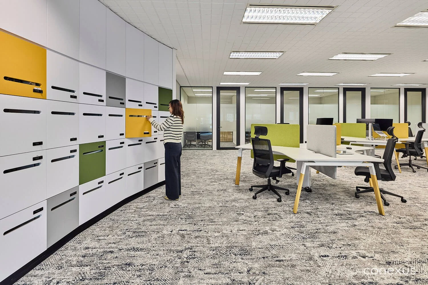 A curved wall of lockers, colour-blocked in Custera's yellow, green, and grey, turns everyday storage into a quiet expression of brand. 