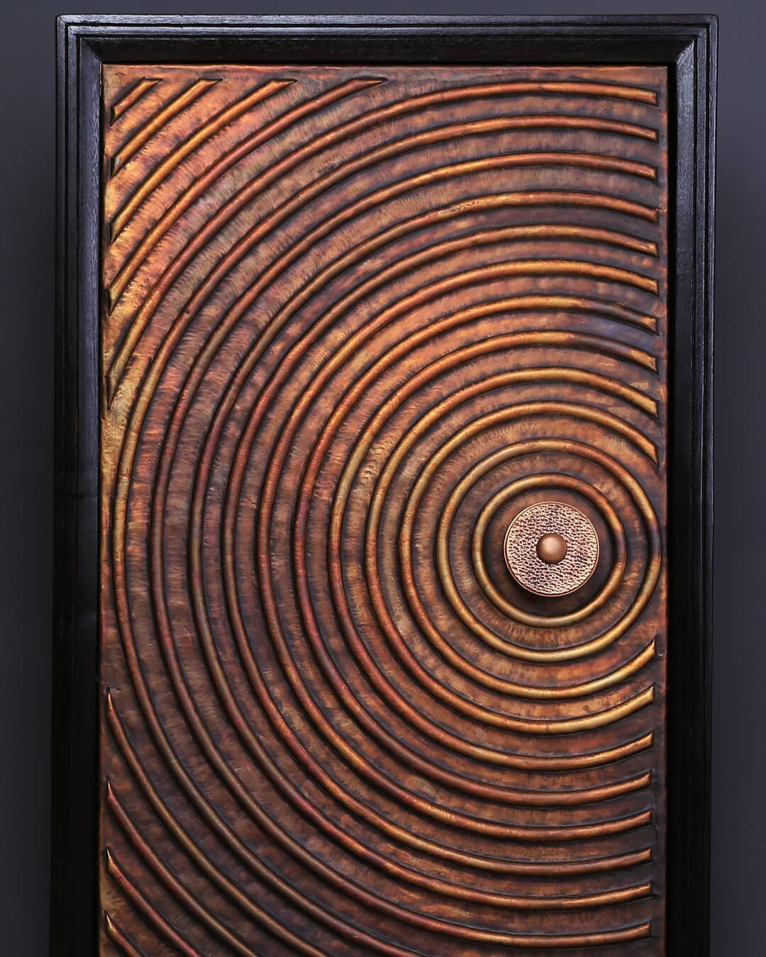 This is not an abstract art ...............
Inspired by geometry,  our concentric aura copper door is a true reflection of our passion for art and urge of elevating art and architecture. 
Each circle is precisely made by hand . Where the copper skin 