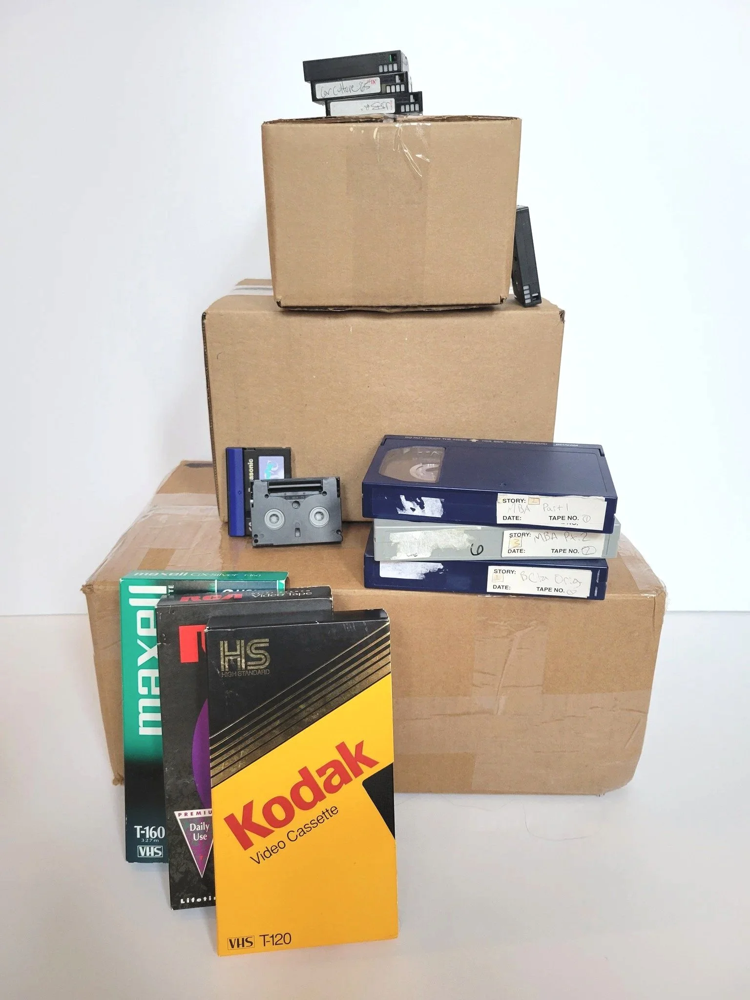 A stack of shipping boxes with video tapes stacked on top