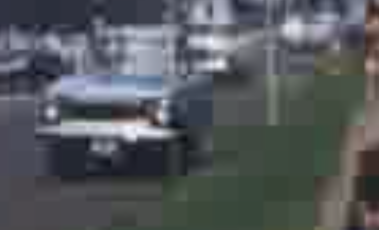 Heavy MPEG compression applied to an image of an old blue car. The compression is so severe that everything is blocky and pixelated.