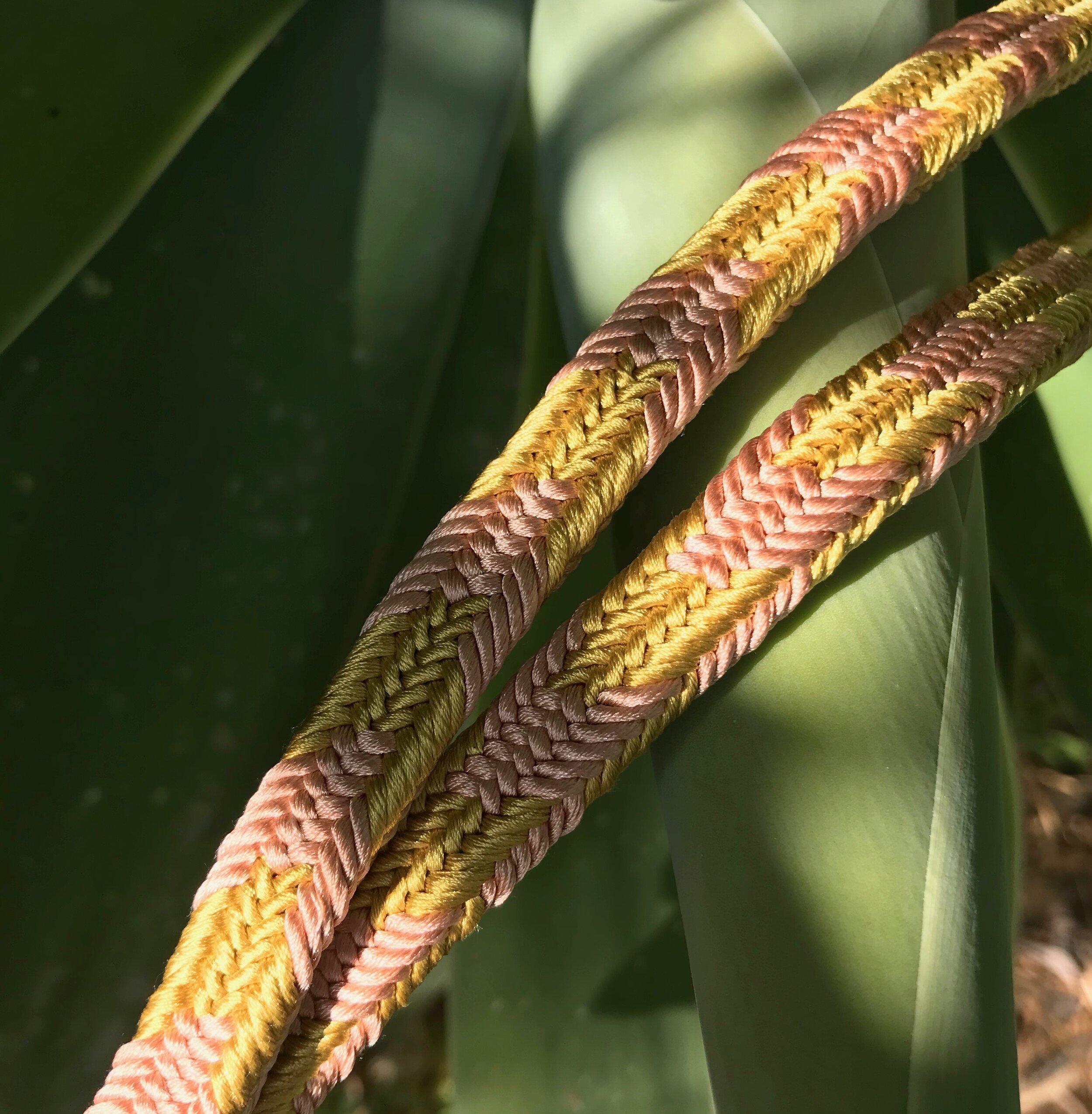 Long Key Strap made out of silk, in the colors rose and yellow, with a purple finish