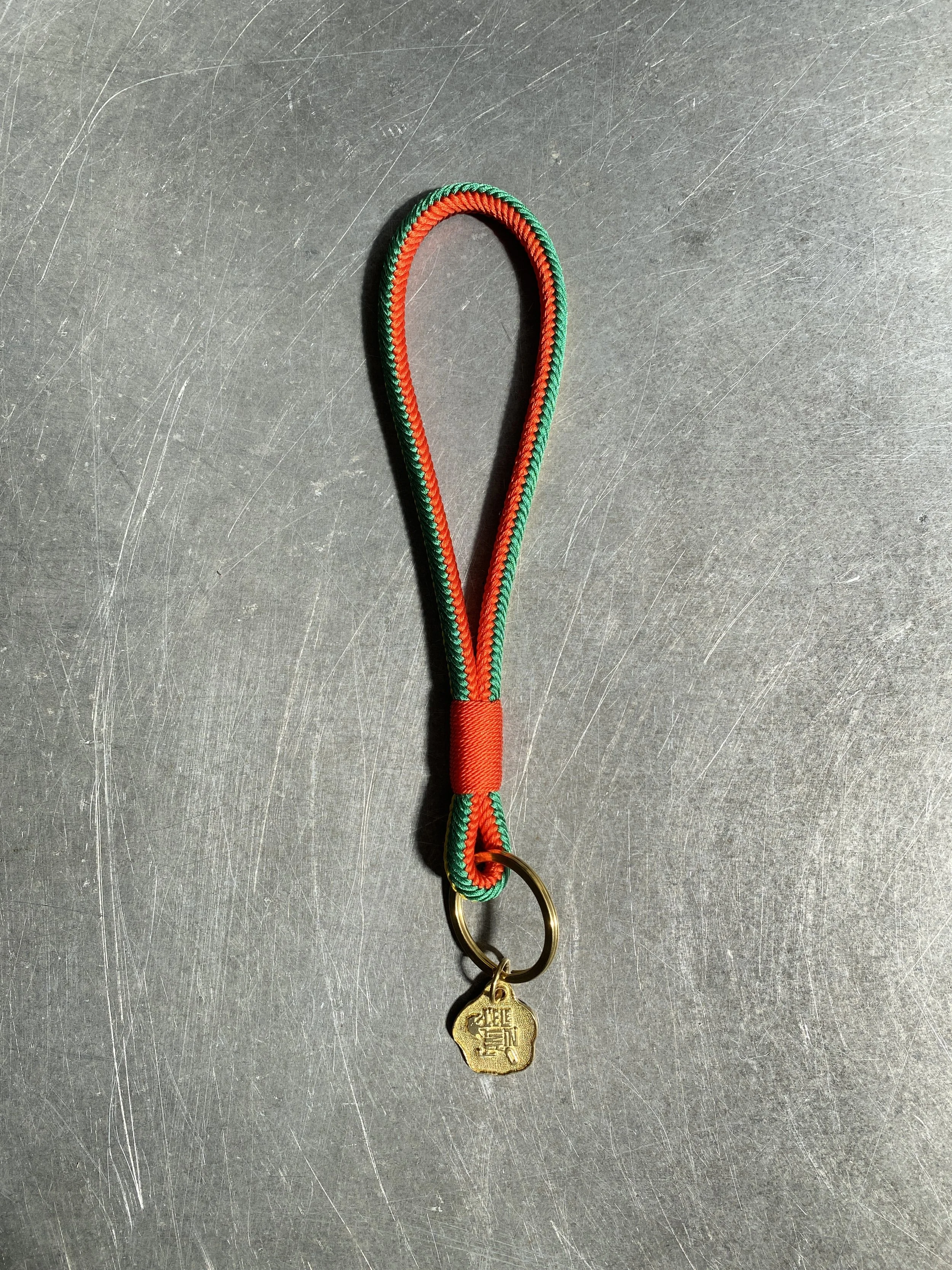 Short Key Strap made out of silk, in the colors orange, yellow, green, dark red,