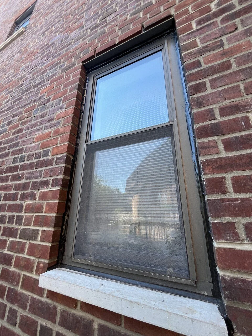 Upclose brick and window facade with repairs by Rojas AP.jpeg