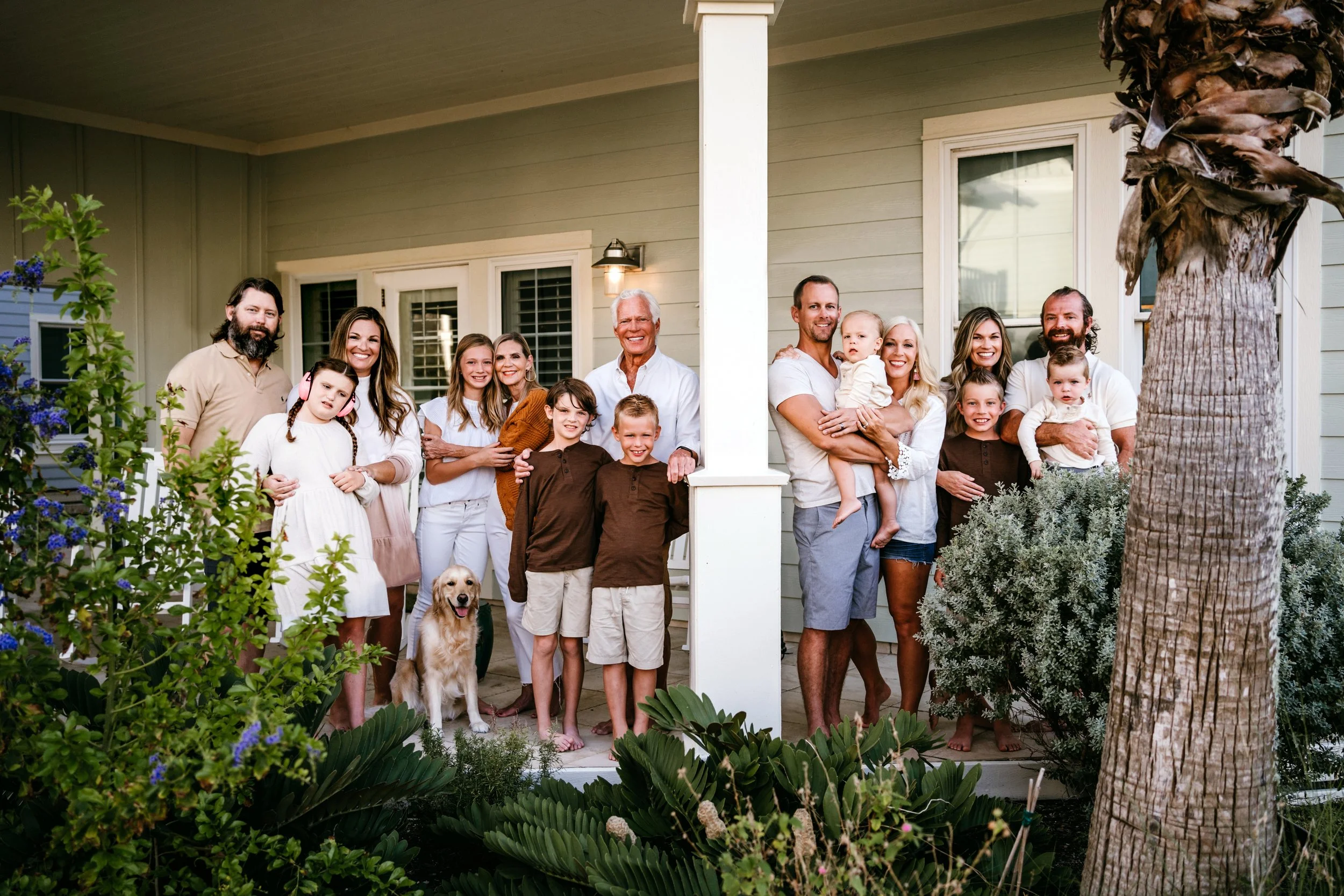 family standing on beach porch