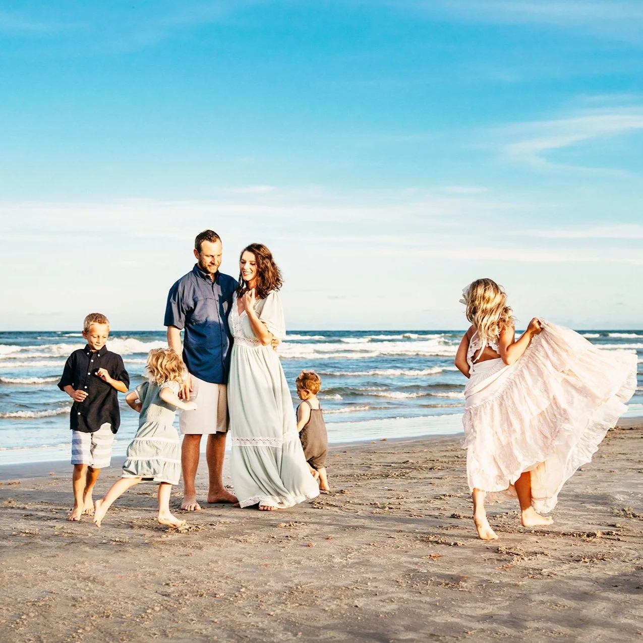 Port Aransas beach family photographer mom dad 4 kids running on beach