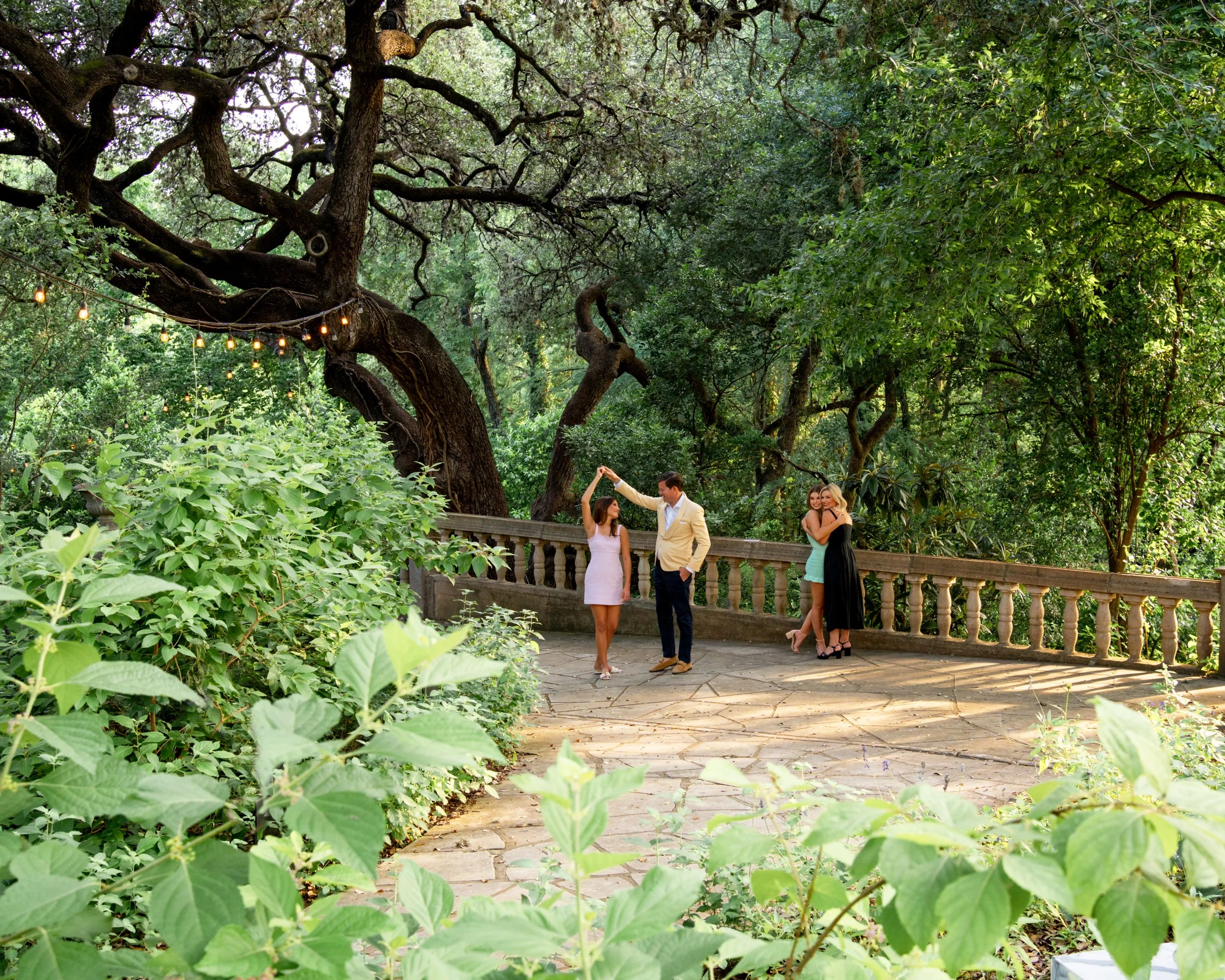 family dancing on bridge