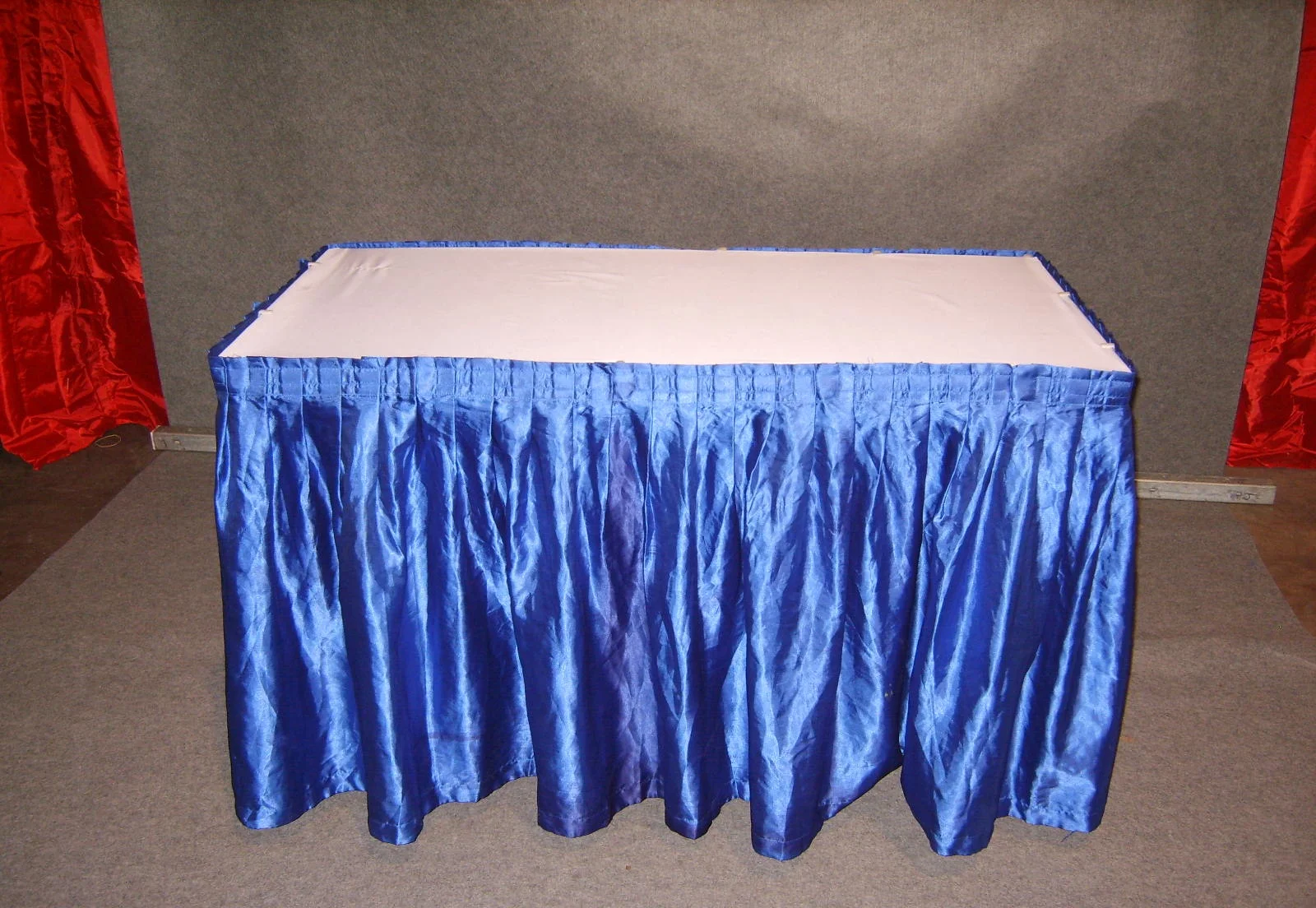 2x4' table w/ blue skirting