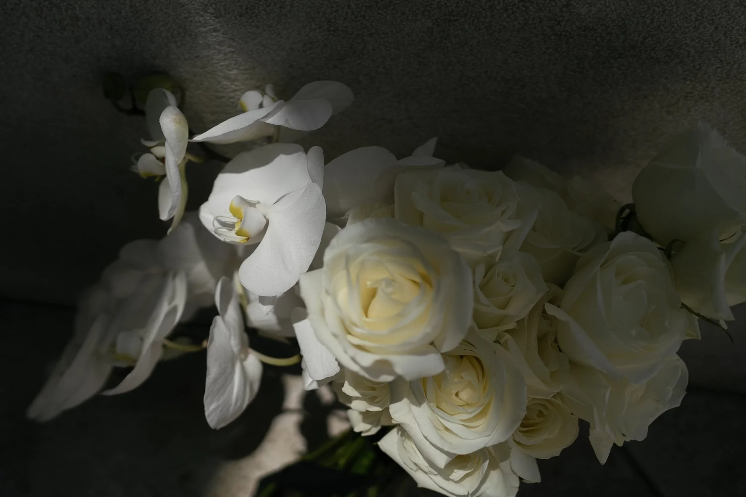 Close-up of a bridal bouquet of white roses and orchids
