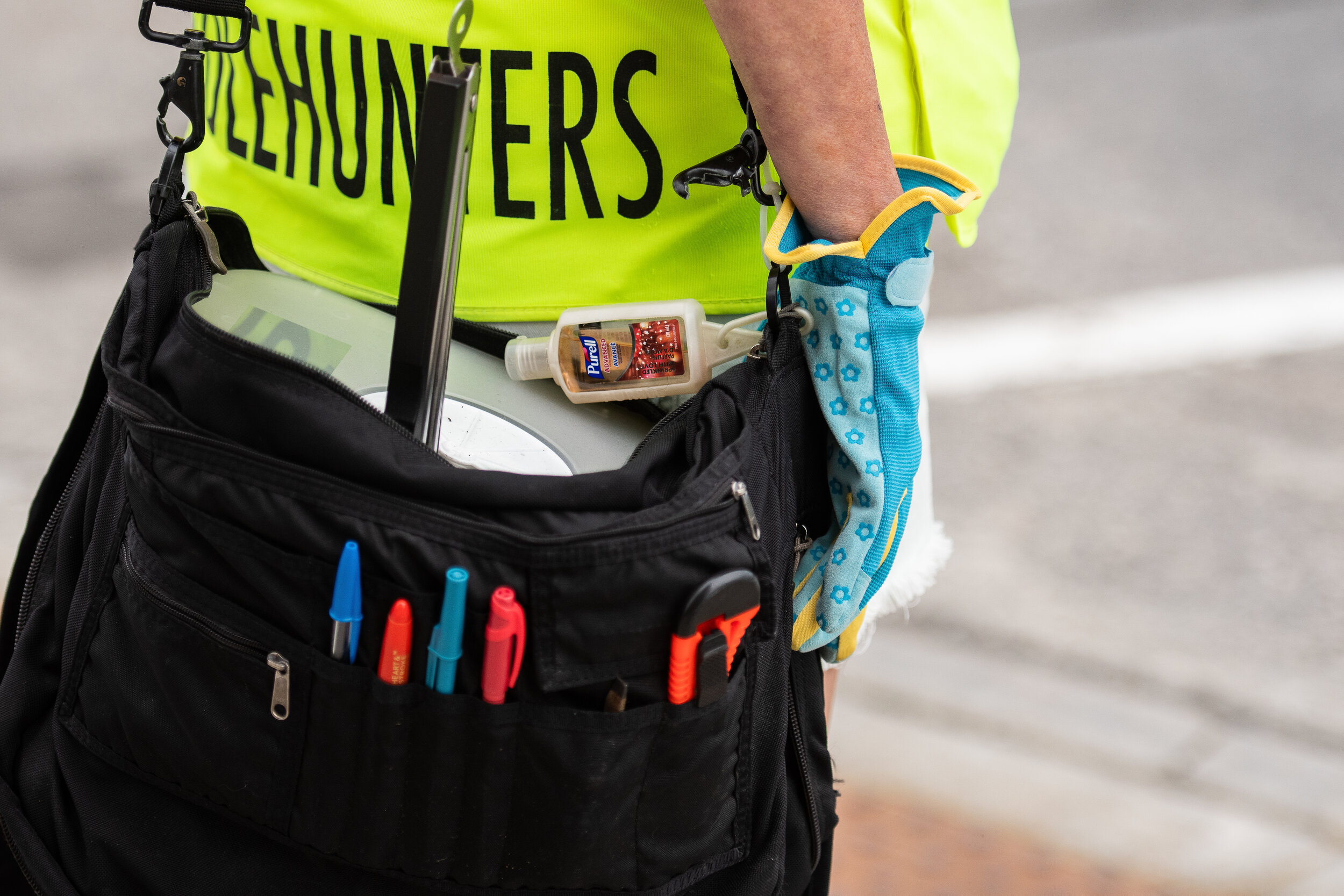  Needle hunters carry bags equipped with a sharp container and kitchen tongs to grab and store drug paraphernalia. Justin Byrne explains the yellow vests are important because they tell drug users hunters are non-threatening and only there to clean. 