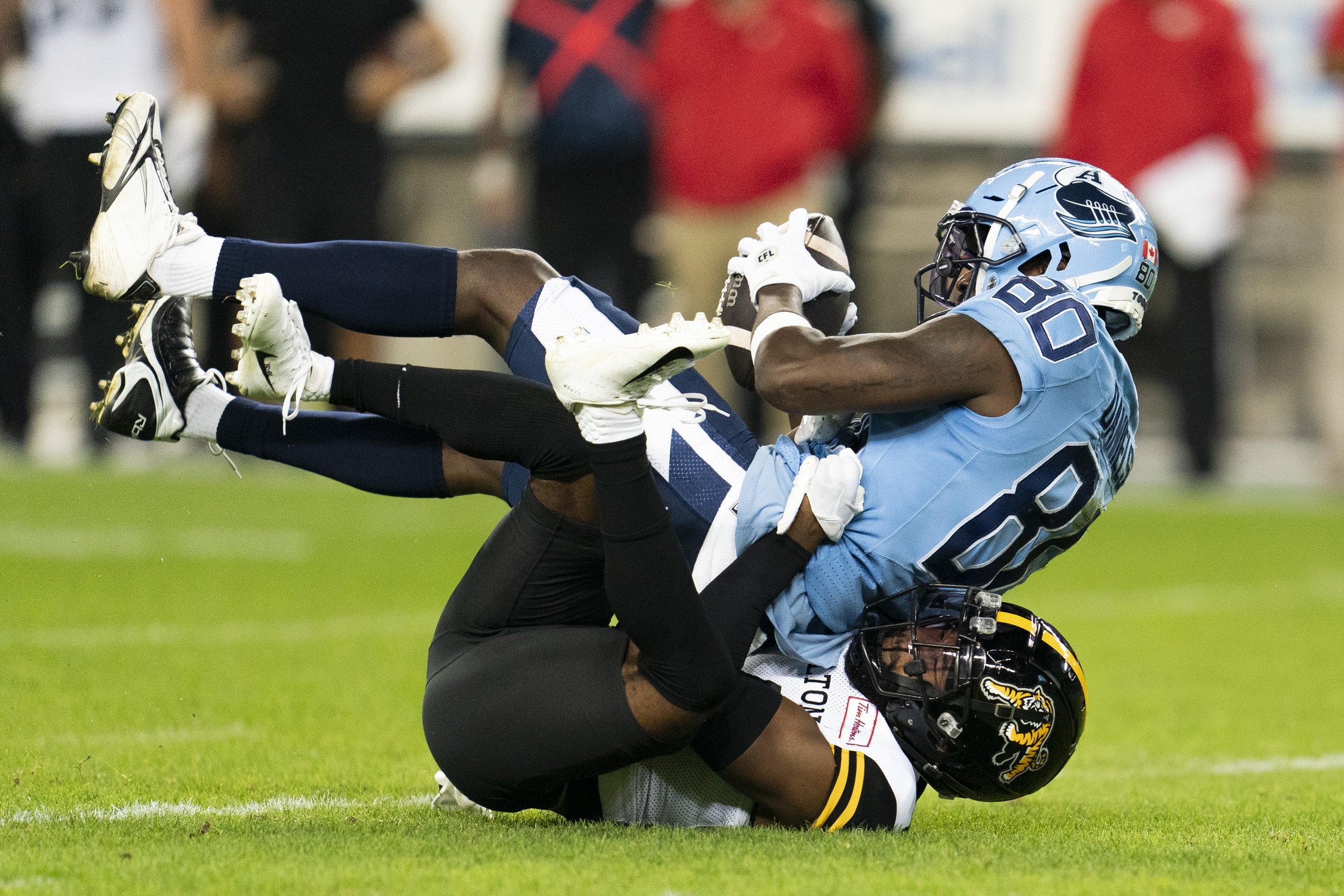  Toronto Argonauts wide receiver DaVaris Daniels (80) is tackled by Hamilton Tiger-Cats receiver Dexter. Lawson Jr (14) during first half CFL football action in Toronto, on Saturday, Sept. 23, 2023. THE CANADIAN PRESS/Spencer Colby 