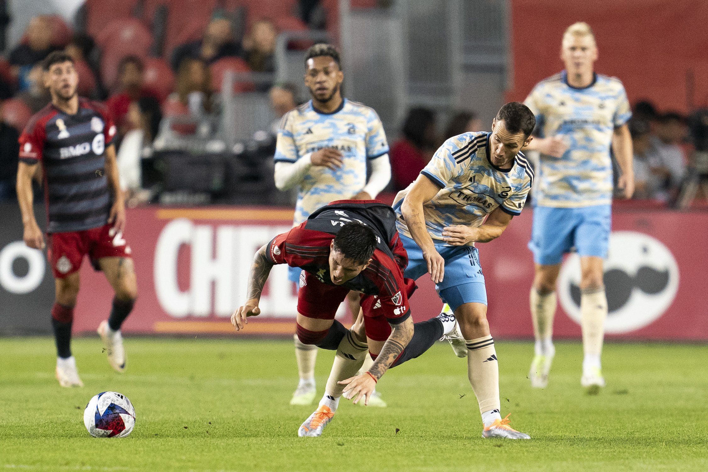  Toronto FC midfielder Franco Ibarra (5) is tripped up by Philadelphia Union midfielder Daniel Gazdag (10) during first half MLS soccer action in Toronto, on Wednesday, Aug. 30, 2023. THE CANADIAN PRESS/Spencer Colby 