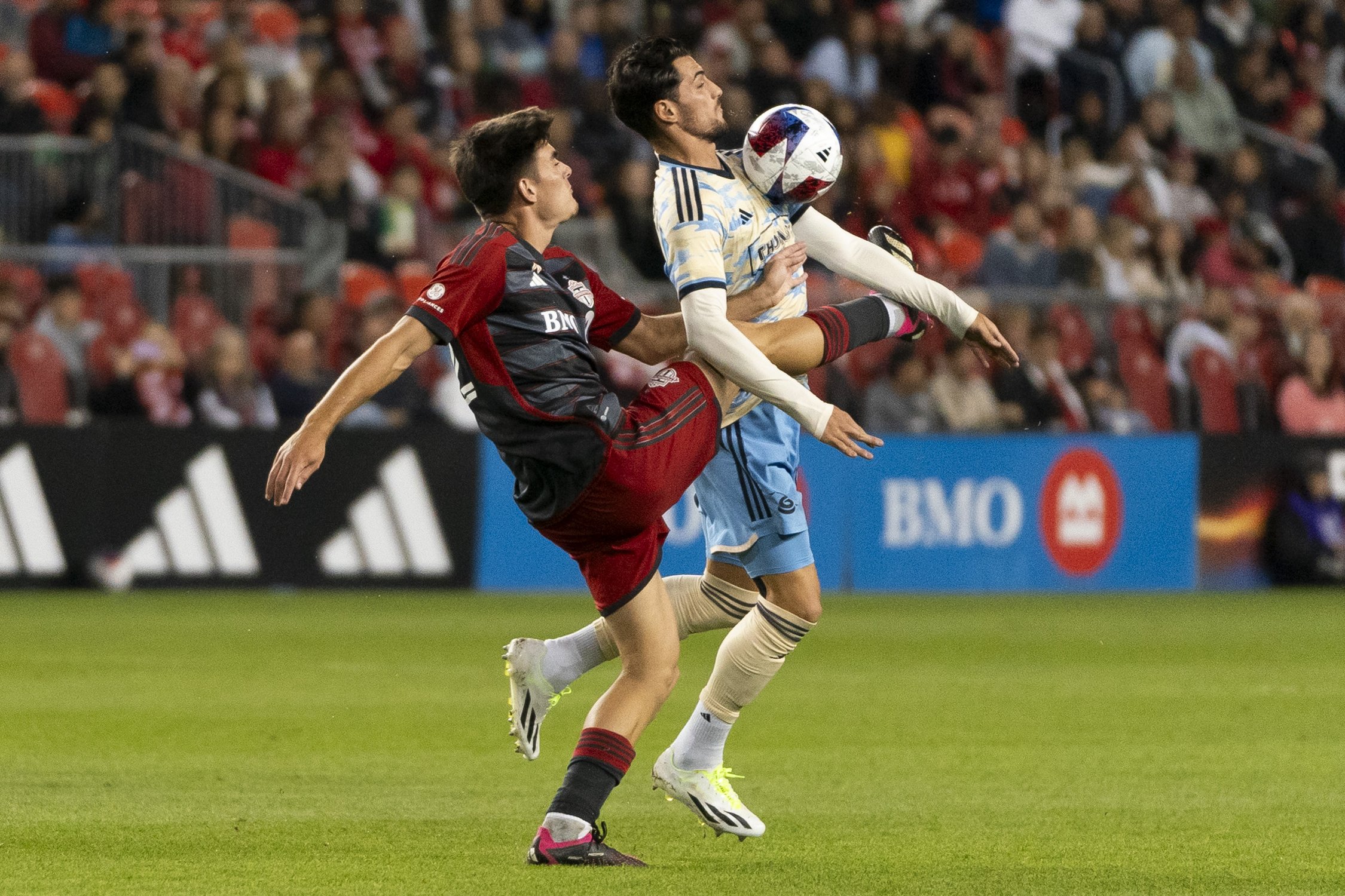  Toronto FC midfielder Alonso Coello (52) and Philadelphia Union forward Julián Carranza (9) fight for control of the ball during second half MLS soccer action in Toronto, on Wednesday, Aug. 30, 2023. THE CANADIAN PRESS/Spencer Colby 