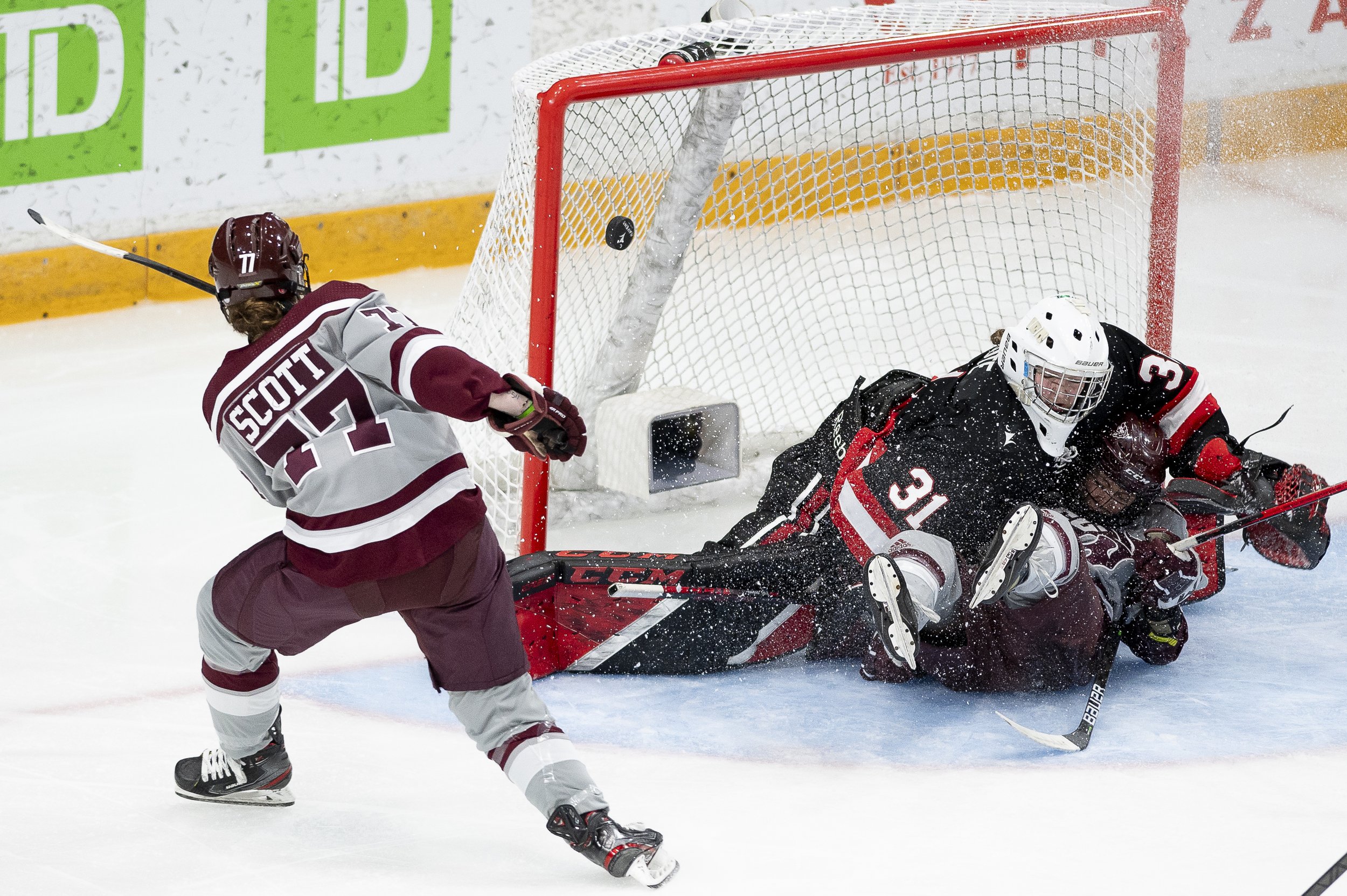  uOttawa Gee-Gees forward Taylor Scott (77) attempts a shot on net as a uOttawa Gee-Gees player crashes into Carleton Ravens goaltender Marie-eve Cote (31) during the Alerts Cup matchup in Ottawa, on Sunday, Jan. 22, 2023. Spencer Colby/The Charlatan