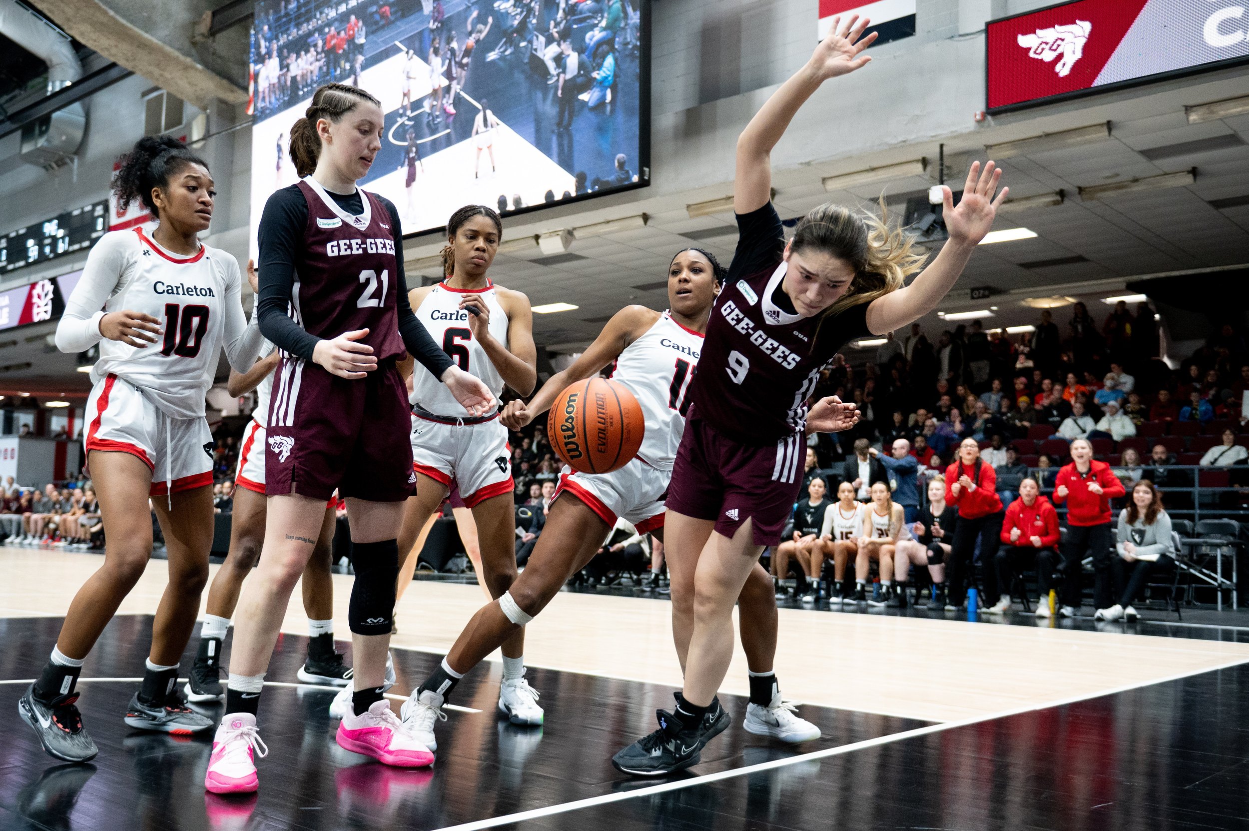  University of Ottawa Gee-Gees point guard Natsuki Szczokin (9) falls out of bounds as Carleton Ravens' guard Kyana-Jade Poulin (11) looks on during the second half of the annual Capital Hoops Classic rivalry game at TD Place in Ottawa, on Friday, Fe