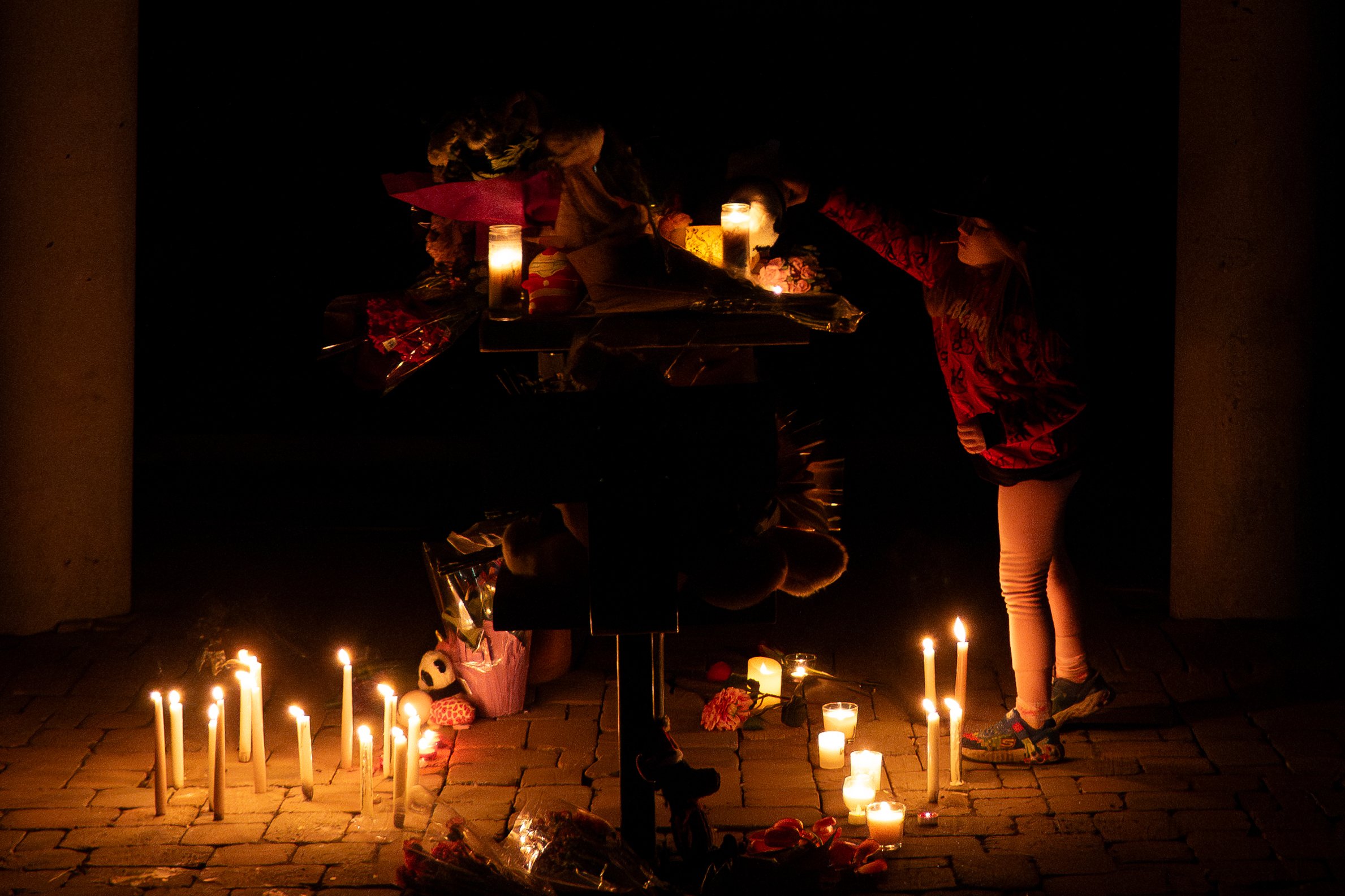  A young child places a stuffed toy on a table at a vigil at Palmadeo Park in Ottawa near the scene where six people, including a mother and her four children, were killed late Wednesday night. The killings are being described as one of the city’s wo