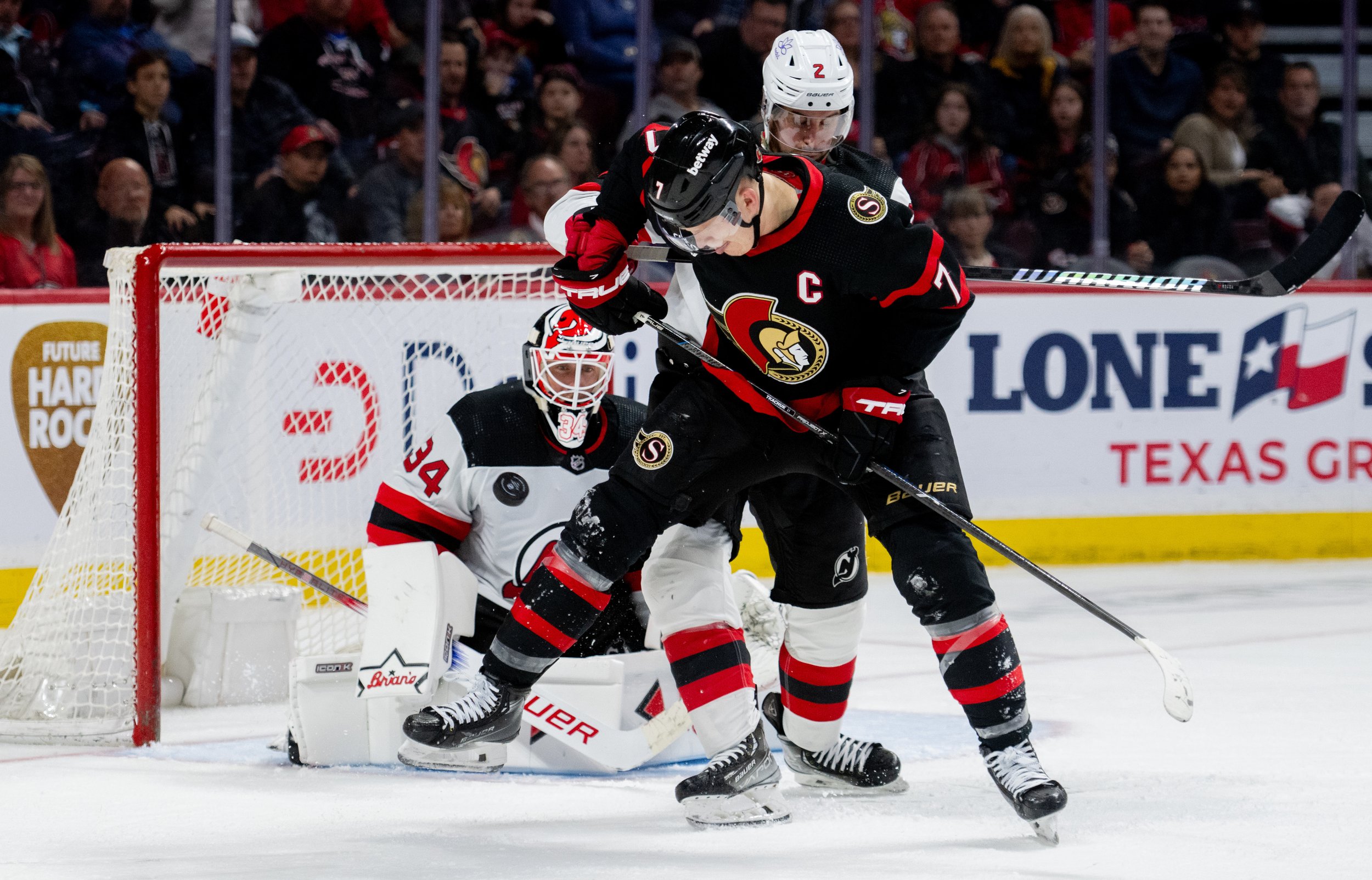  Ottawa Senators left wing Brady Tkachuk (7) attempts to deflect a shot as New Jersey Devils goaltender Jake Allen (34) tracks the puck during the third period of NHL action in Ottawa, on Saturday, April 6, 2024. THE CANADIAN PRESS/Spencer Colby 