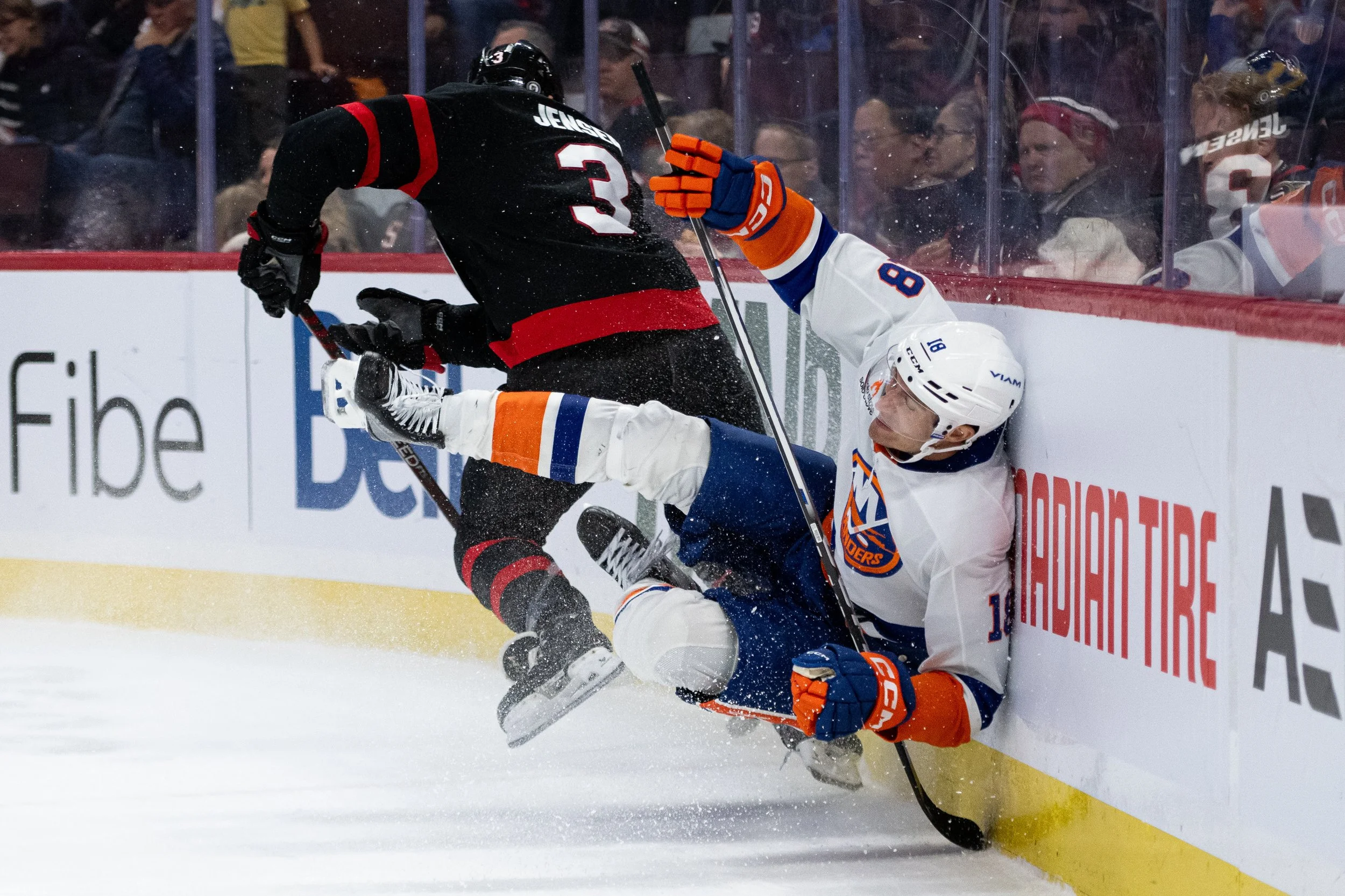  Ottawa Senators defenceman Nick Jensen (3) collides with New York Islanders left wing Pierre Engvall (18) during first period NHL hockey action in Ottawa, on Sunday, Dec. 8, 2024. THE CANADIAN PRESS/Spencer Colby 