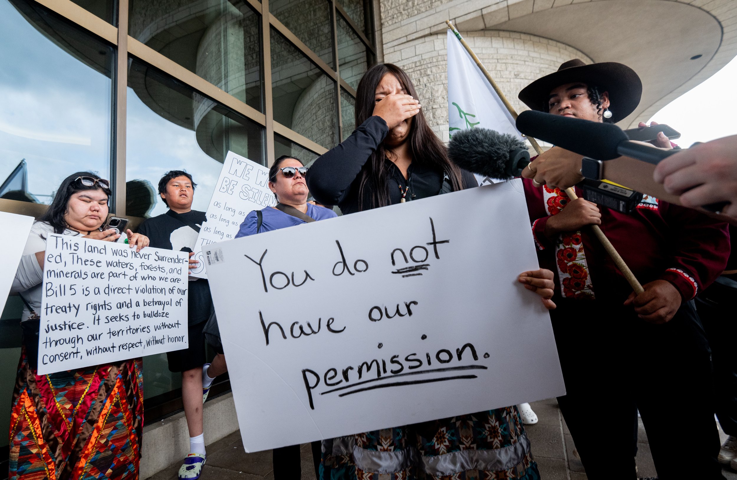  Protester Keisha Paulmartin of Okiniwak Youth Led Movement is overcome with emotion as she speaks to reporters during a protest on the property of the Canadian Museum of History in Gatineau, Que., on Thursday, July 17, 2025. THE CANADIAN PRESS/Spenc