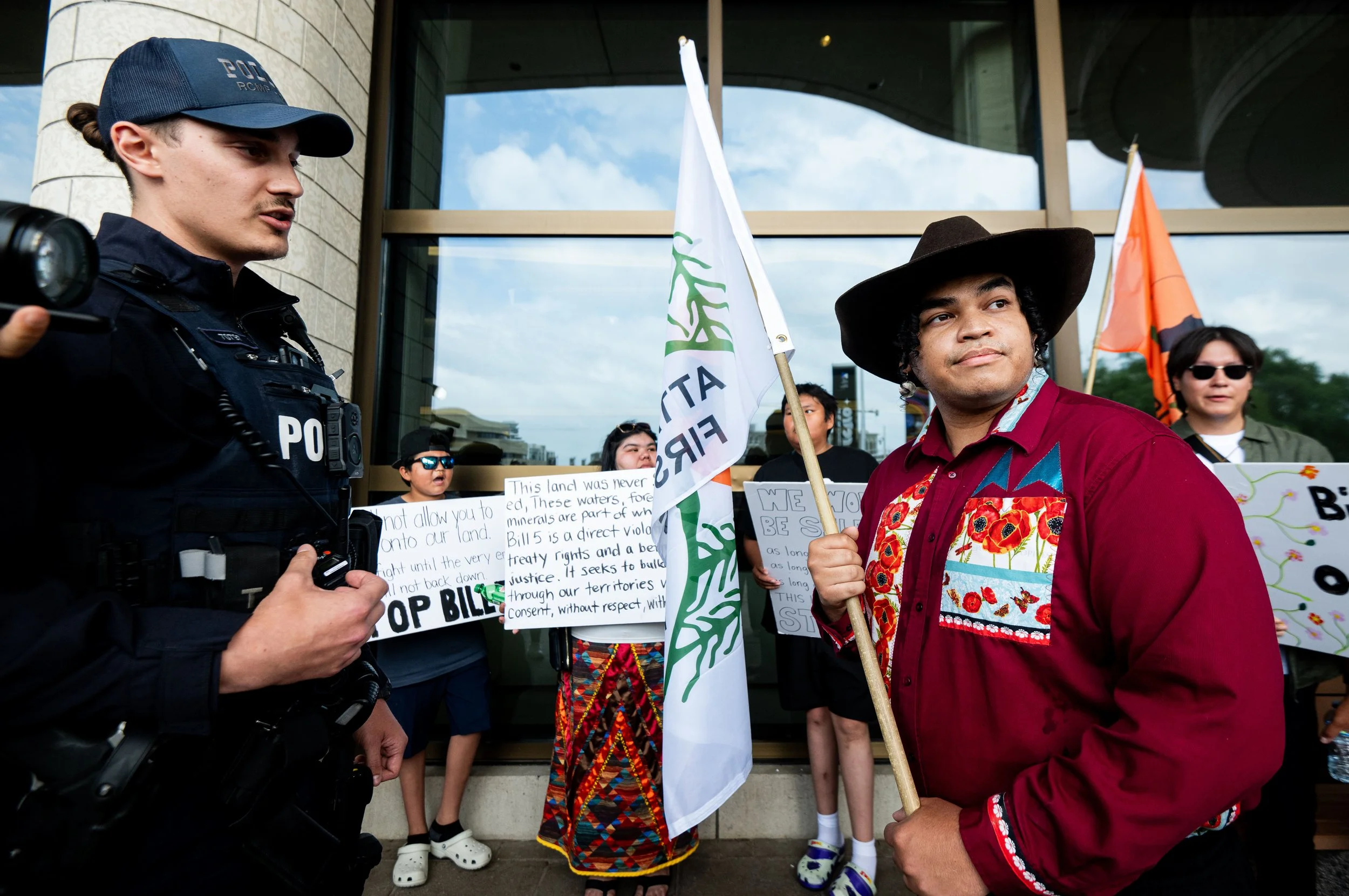  Protest organizer Ramon Kataquapit from the Okiniwak Youth Led Movement, right, reacts after being told to move off of the property of the Canadian Museum of History by a Royal Canadian Mounted Police officer during the First Nations Summit in Gatin