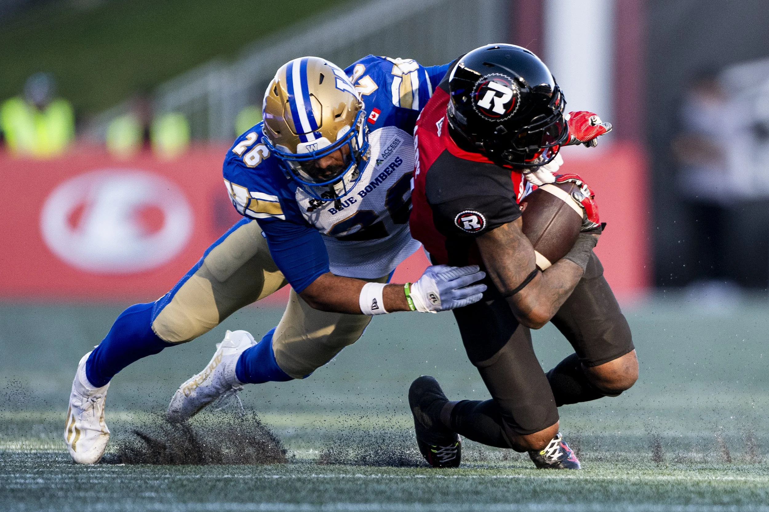  Winnipeg Blue Bombers defensive back Jaiden Woodbey (26) tackles Ottawa Redblacks wide receiver Justin Hardy (2) during second half CFL action in Ottawa, on Saturday, Sept. 20, 2025. THE CANADIAN PRESS/Spencer Colby 