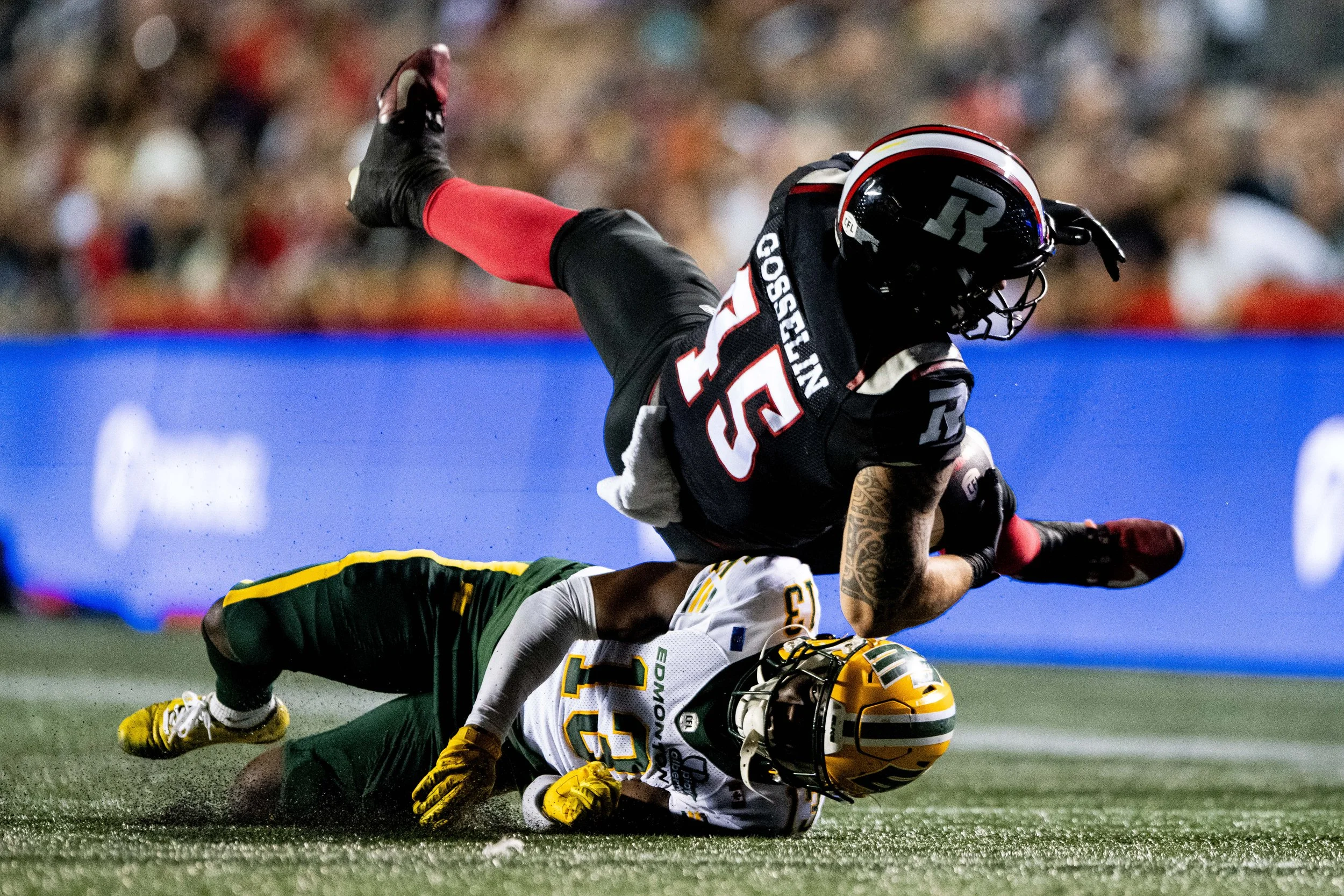  Ottawa Redblacks running back Anthony Gosselin (45) lands on Edmonton Elks defensive back Kordell Jackson (13) as he is tackled during second half of CFL action in Ottawa, on Friday, Aug. 22, 2025. THE CANADIAN PRESS/Spencer Colby 