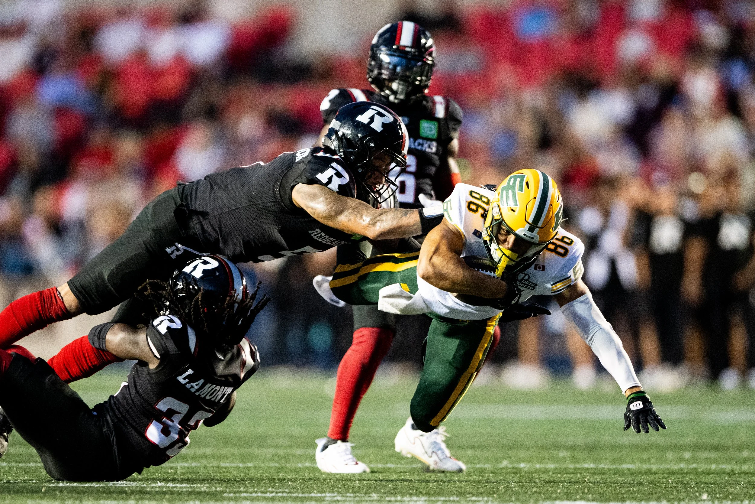  Edmonton Elks wide receiver Arkell Smith (86) is tackled by Ottawa Redblacks linebacker Jovan Santos-Knox (5) during first half of regular season CFL action in Ottawa, on Friday, Aug. 22, 2025. THE CANADIAN PRESS/Spencer Colby 