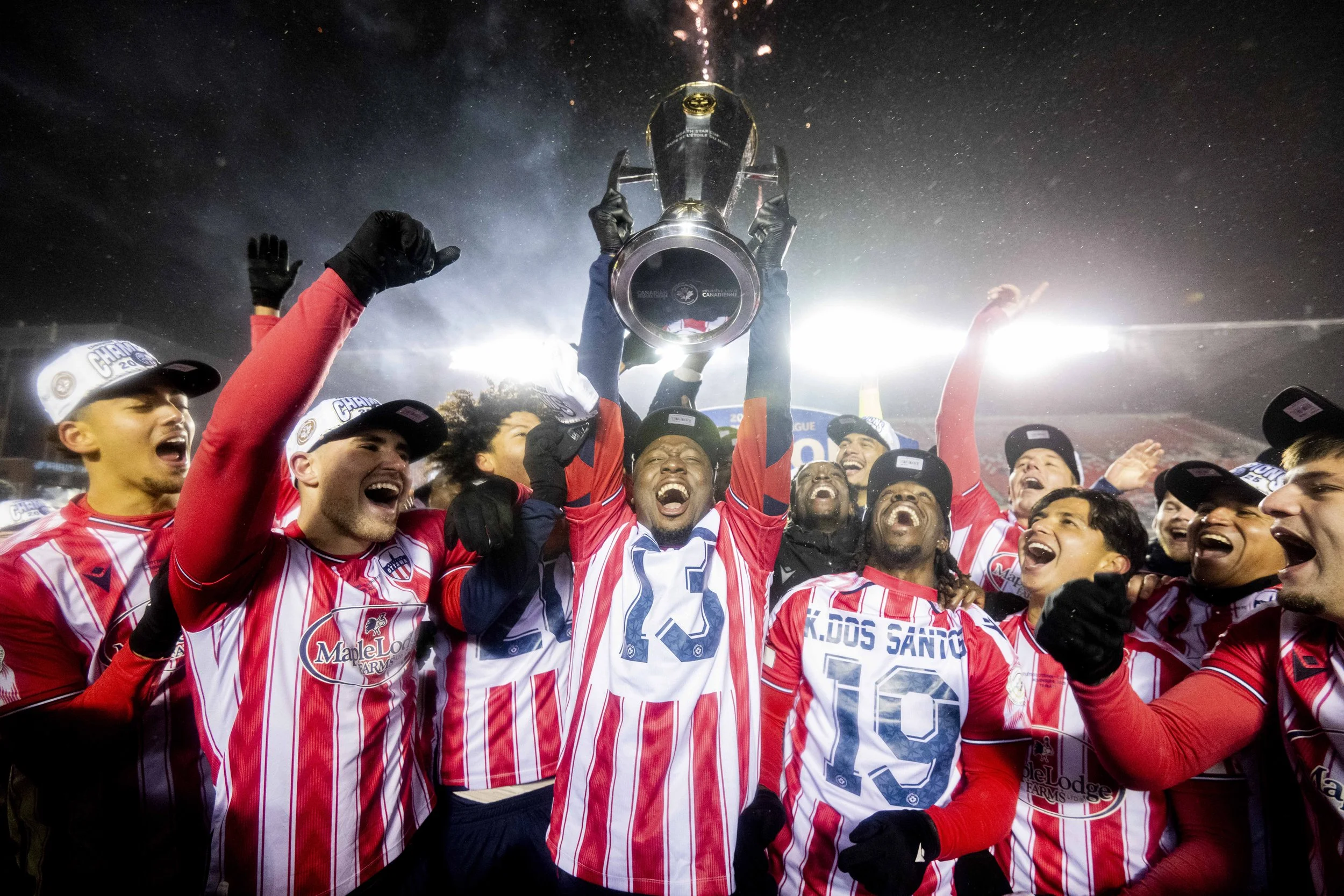  Atletico Ottawa's Ballou Tabla (13) raises the North Star Cup following Atletico Ottawa’s victory over Cavalry FC in extra time during the Canadian Premier League finals soccer action in Ottawa, on Sunday, Nov. 9, 2025. THE CANADIAN PRESS/Spencer Co