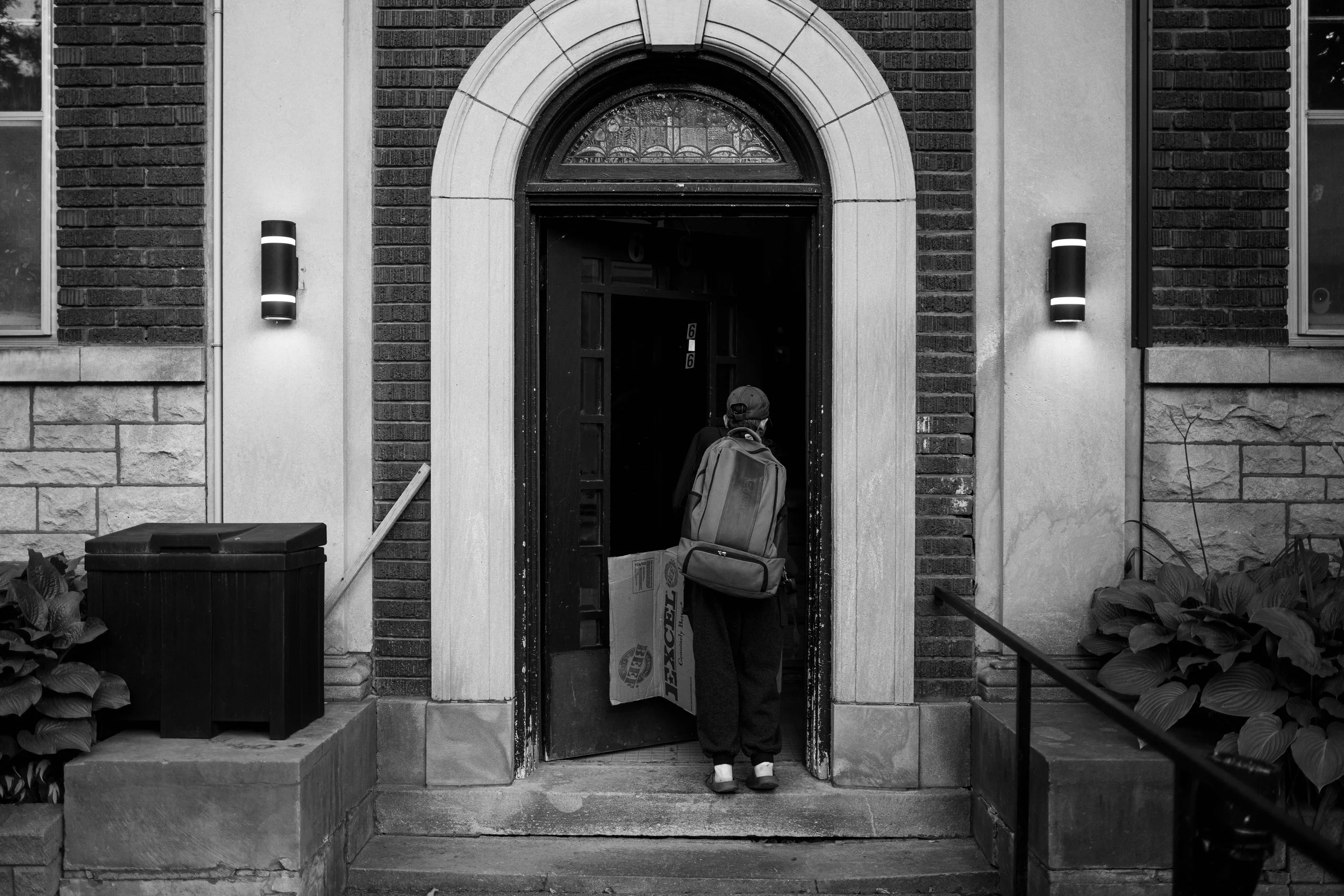  Thumper holds a cardboard box as she enters the front door of her apartment building in Ottawa’s Glebe neighbourhood 