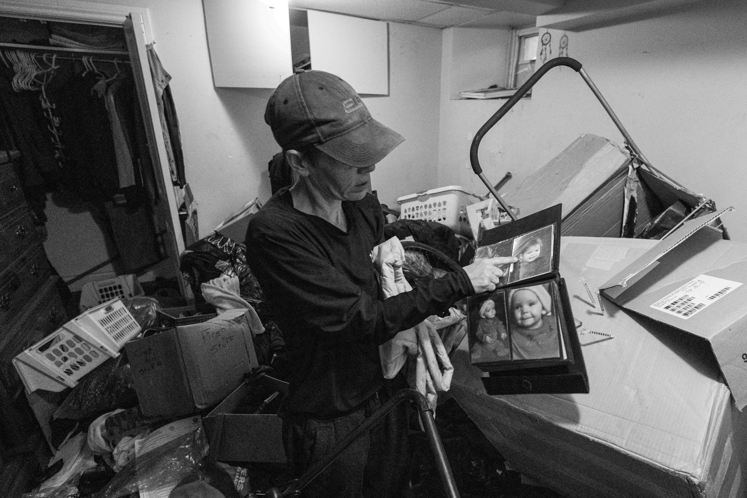  Thumper flips through a family photo album after finding the album in a pile of trash in the bedroom of her one bedroom apartment unit in the Glebe neighbourhood of Ottawa 