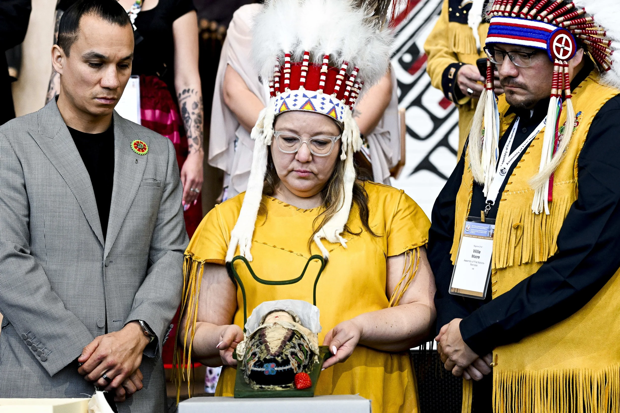  Assembly of First Nations Chief Cindy Woodhouse Nepinak, centre, holds a Tikinagan baby cradle as sacred items are unveiled following their return from Vatican collection during an unveiling event at the Canadian Museum of History in Gatineau, Que.,