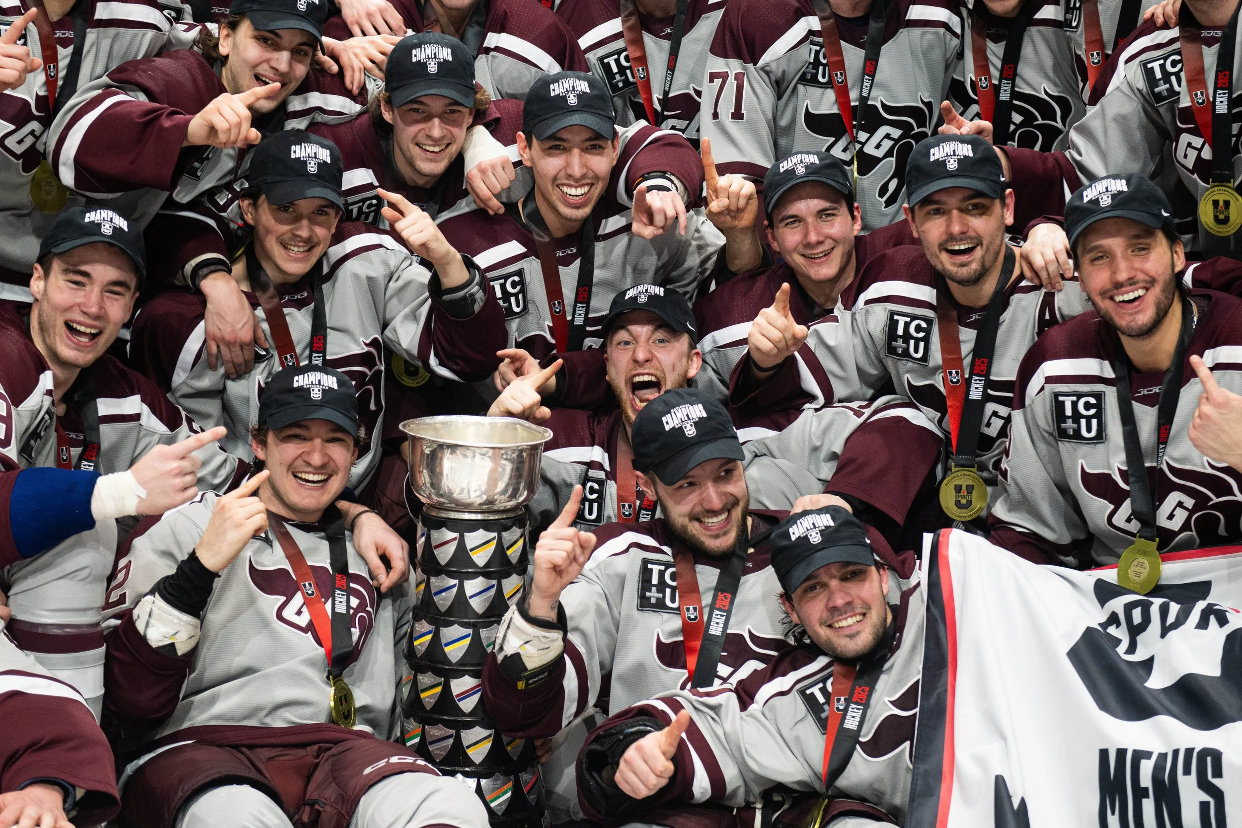  University of Ottawa players celebrate their win over Concordia University following third period U Sports University Cup Men's Hockey Championship gold medal action in Ottawa, on Sunday, March 23, 2025. University Affairs/Spencer Colby 