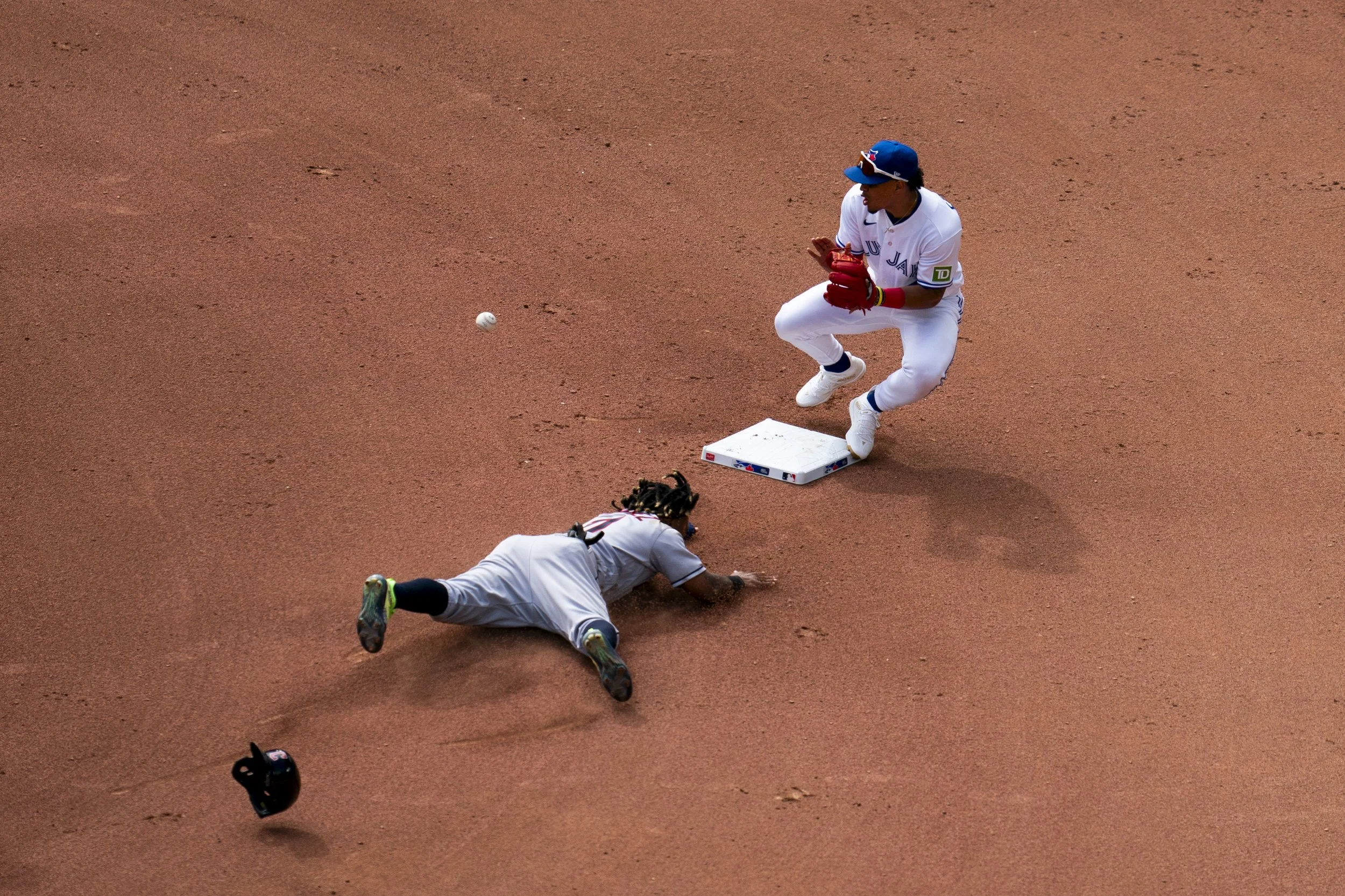  Cleveland Guardians third baseman Jose Ramirez (11) slides into second base as Toronto Blue Jays second baseman Santiago Espinal (5) attempts a tag from a pitch by Toronto Blue Jays relief pitcher Genesis Cabrera (92) during seventh inning American 