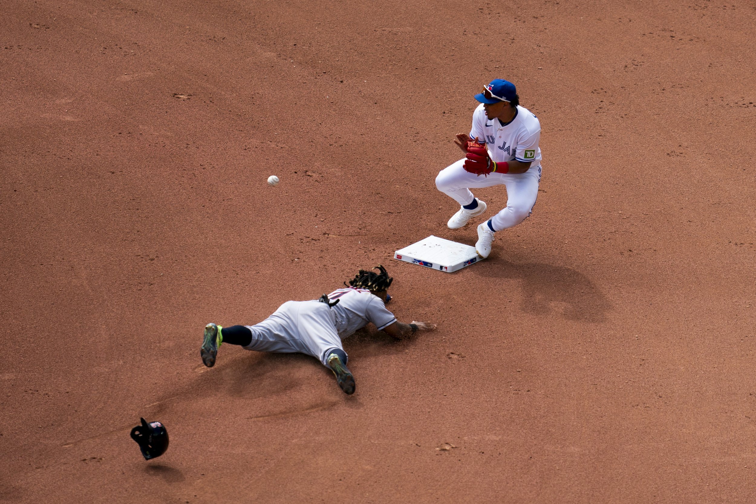  Cleveland Guardians third baseman Jose Ramirez (11) slides into second base as Toronto Blue Jays second baseman Santiago Espinal (5) attempts a tag from a pitch by Toronto Blue Jays relief pitcher Genesis Cabrera (92) during seventh inning American 