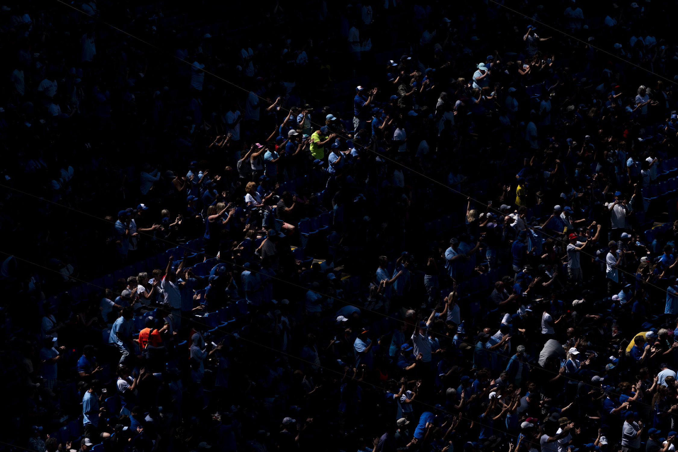  Toronto Blue Jays fans celebrate a two run home by Toronto Blue Jays designated hitter Vladimir Guerrero Jr. (27) (not seen) from a pitch by Cleveland Guardians starting pitcher Noah Syndergaard (34) during first inning American League MLB baseball 