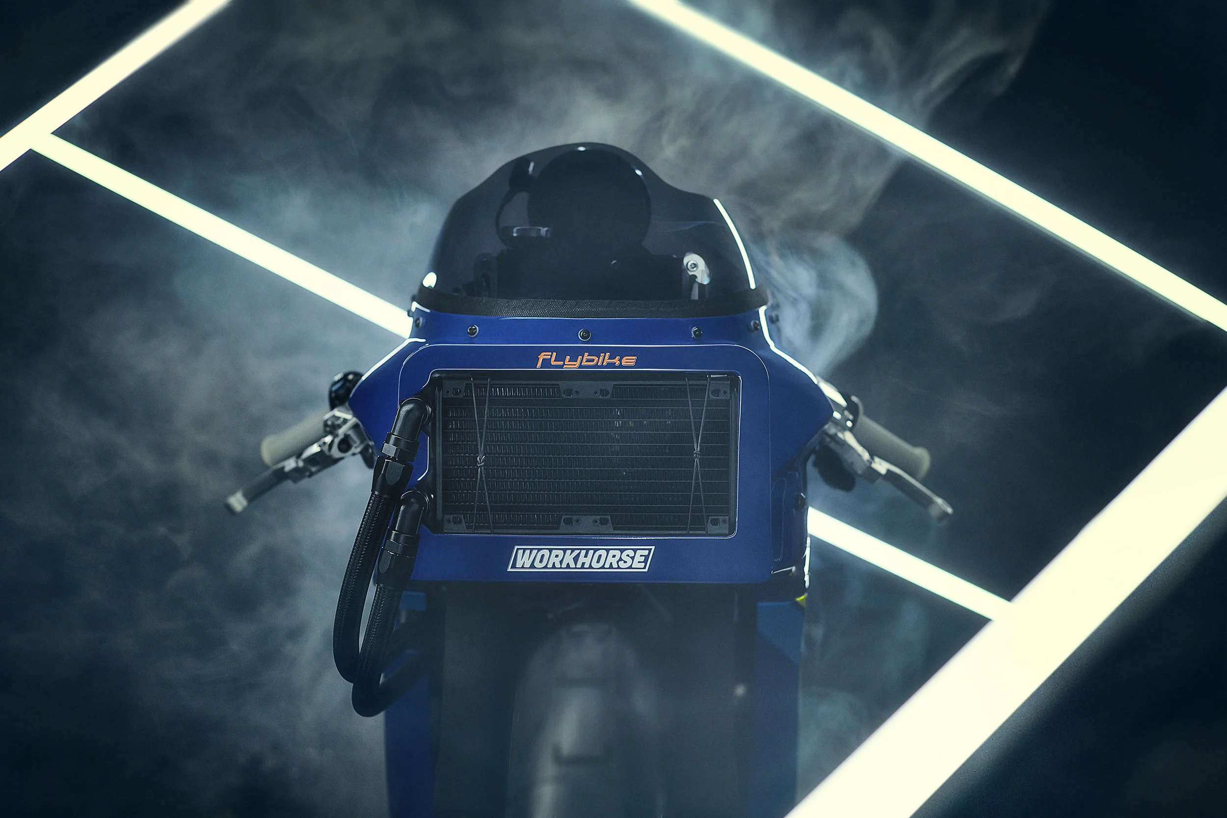 A futuristic robot with a helmet and blue body, standing in front of black smoke and illuminated white neon lights.