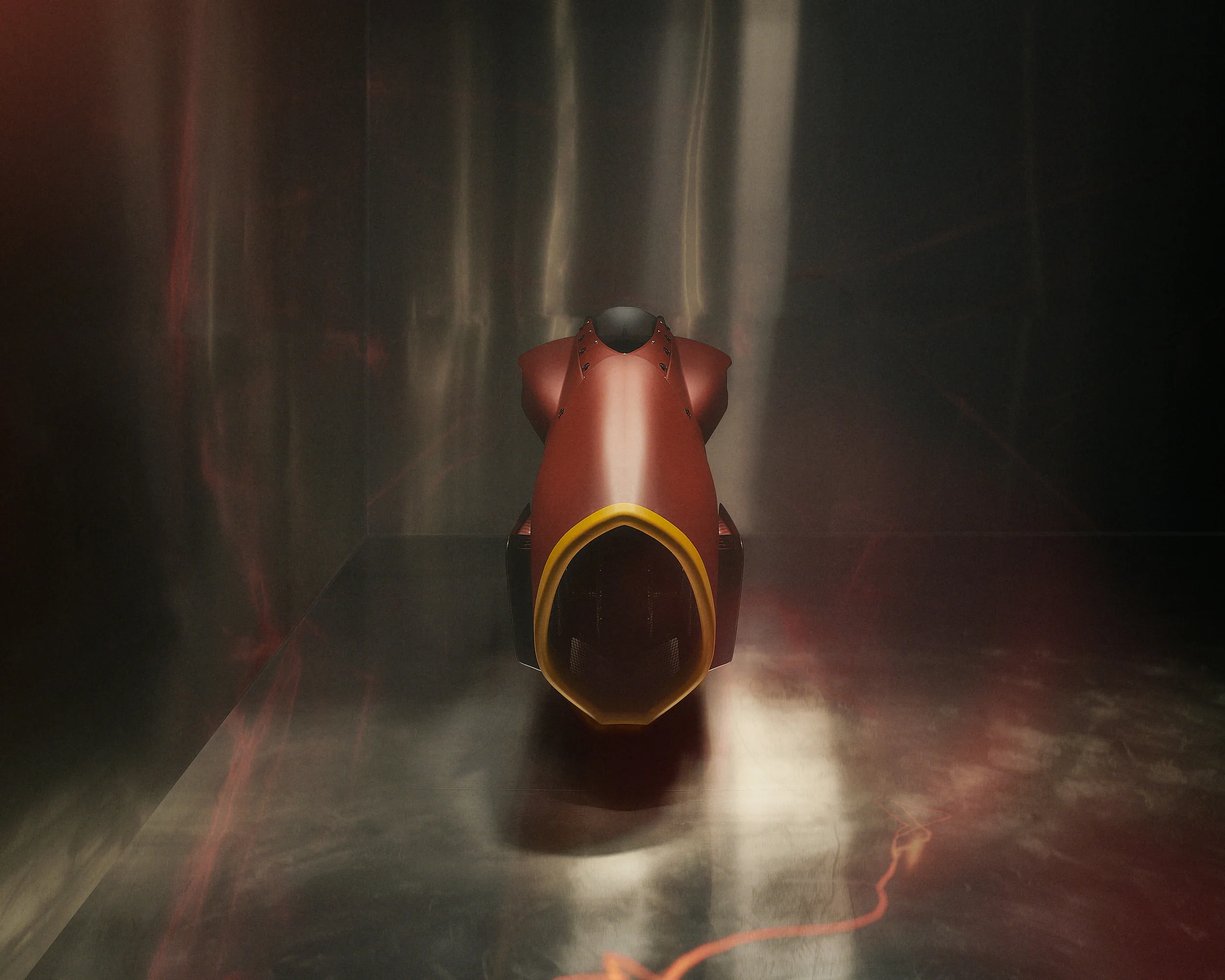 Red vintage race car displayed in a metallic room.