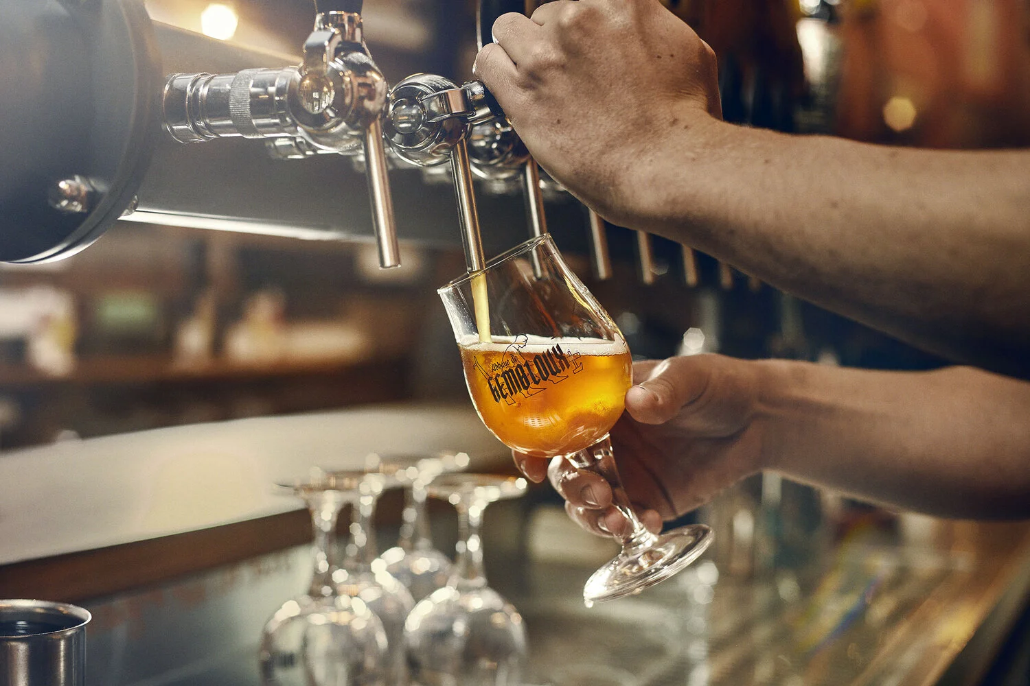 Person pouring beer from tap into a glass with the logo 'La Chouffe' on it.