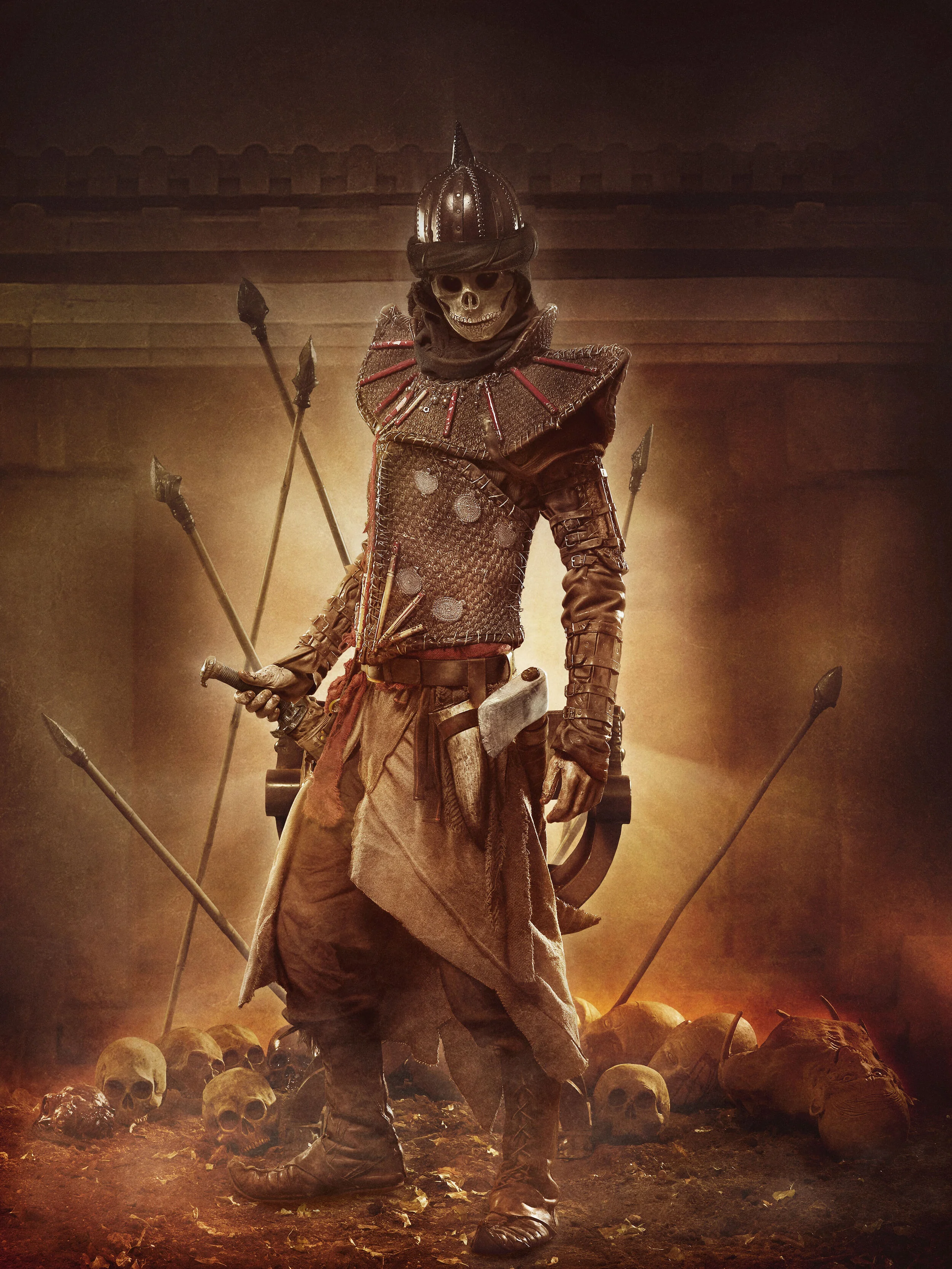 A skeleton dressed as a medieval warrior, wearing a helmet and armor, standing among skulls and bones, with a dark, ominous background.