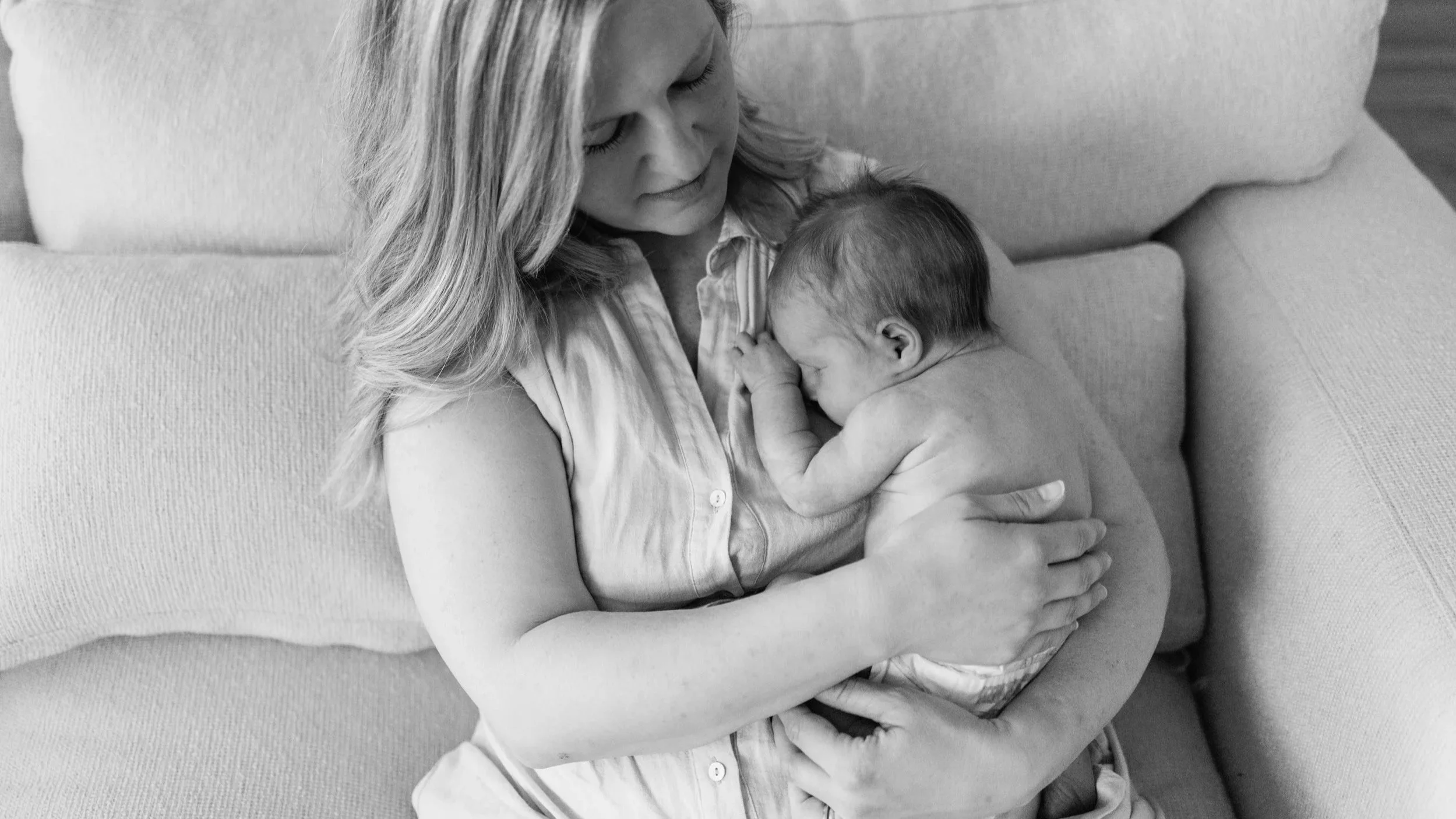 Mother holding a new baby close