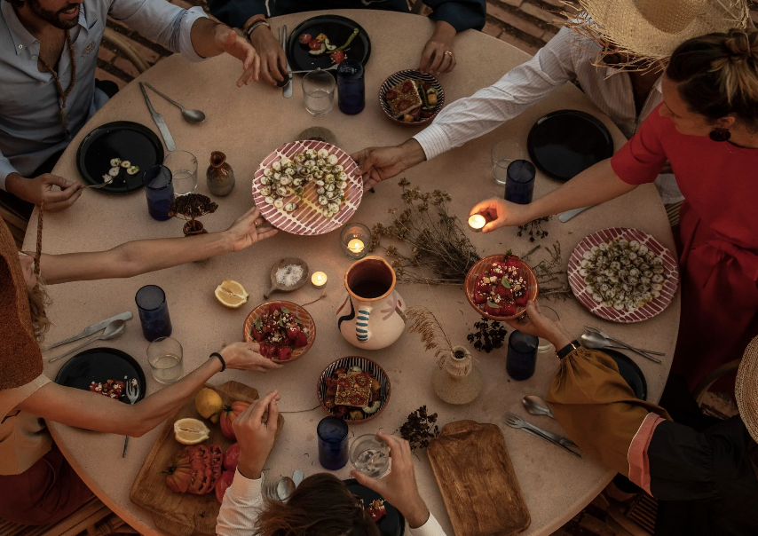 table of sharing platters and people reaching