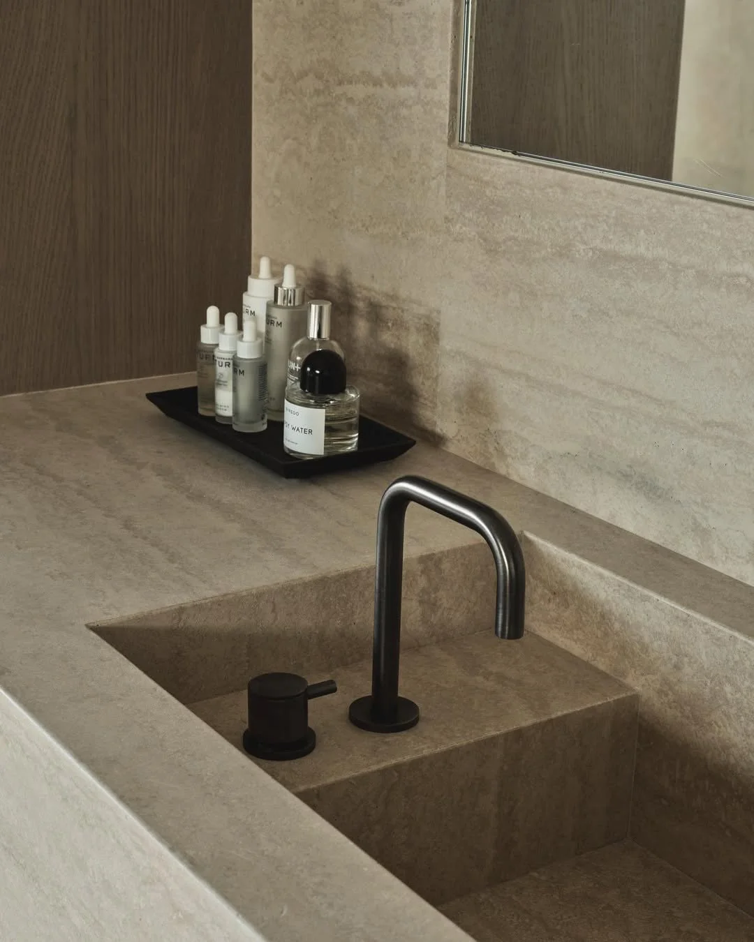 Seamless design meets minimalism.⁠
⁠
A titanium faucet steps down into a beautifully travertine deck-to-sink. The perfect balance between understated elegance and everyday functionality. ⁠
⁠
Discover more options by booking an appointment at the link