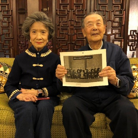 Gloria and Tao Tai Hsia at their home in Washington. Tao Tai holds a photo of Bachelor Harry Rudin in 1921.