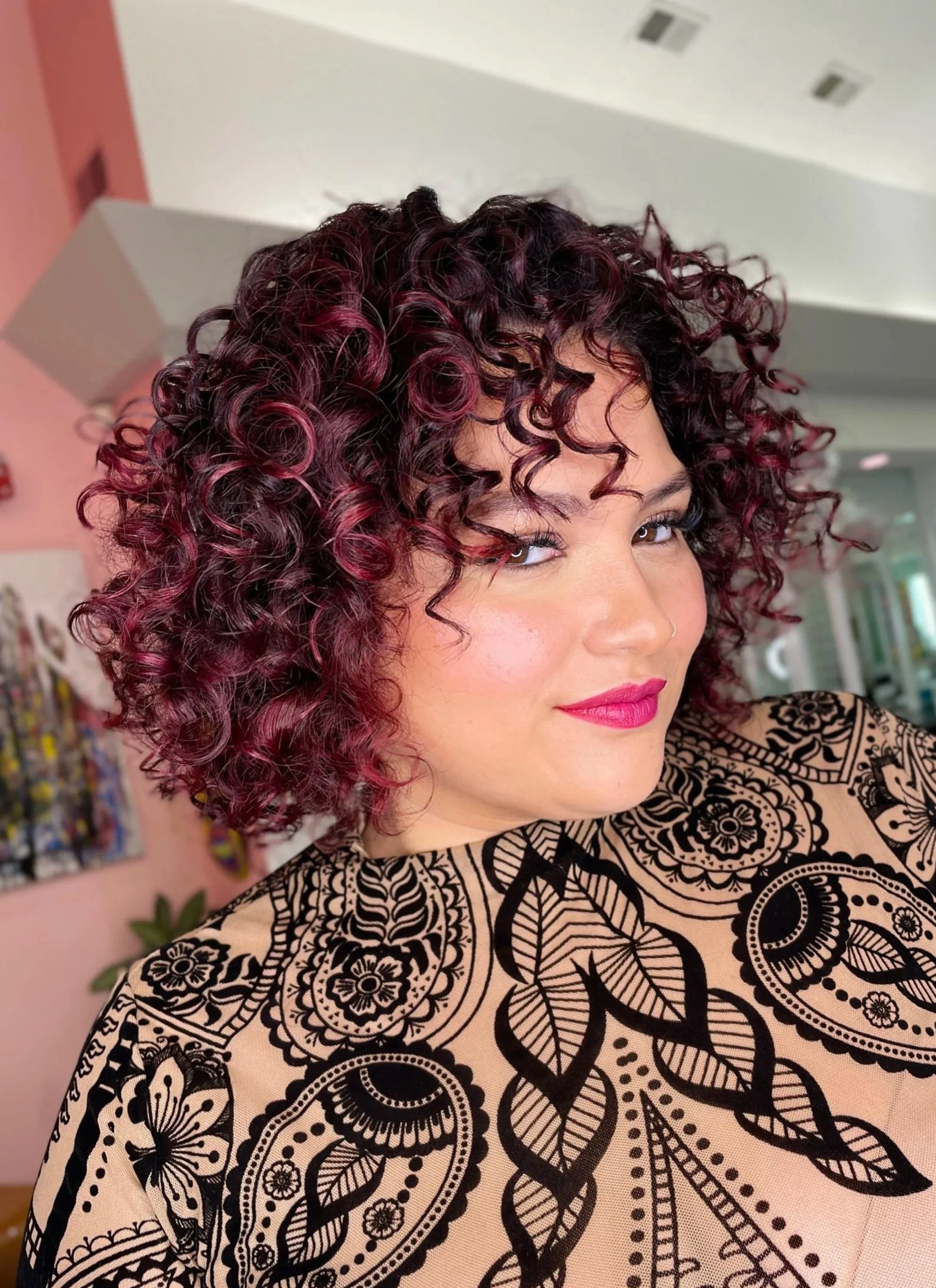 Pink curly haircut in Bergen County, NJ at Bellibone Salon.